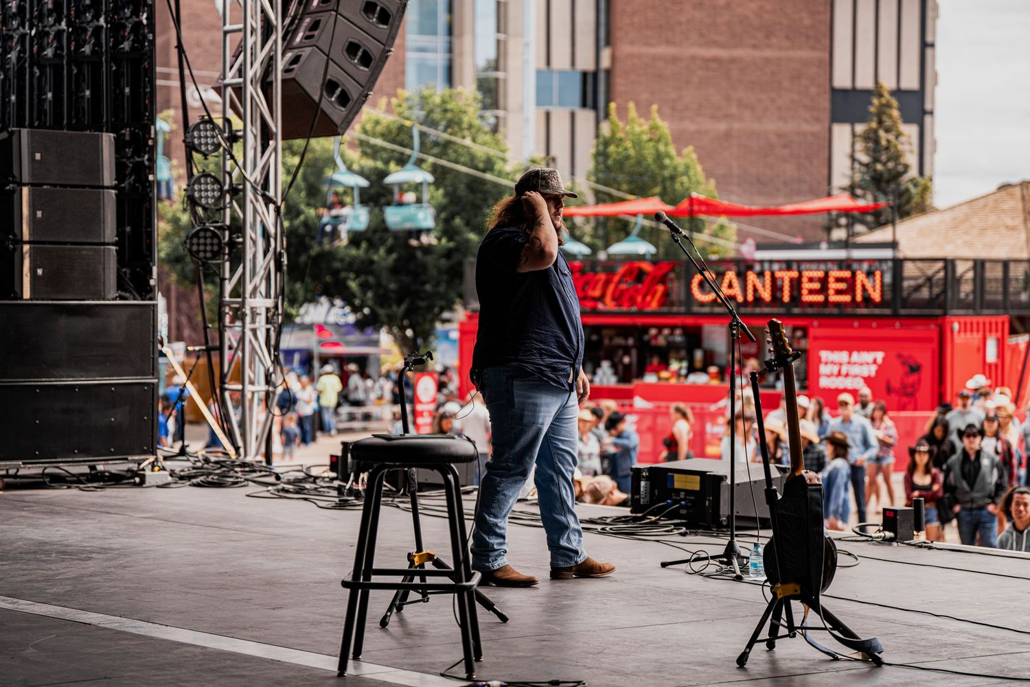 Urban street scene with red Coca-Cola branded food truck and pedestrians.