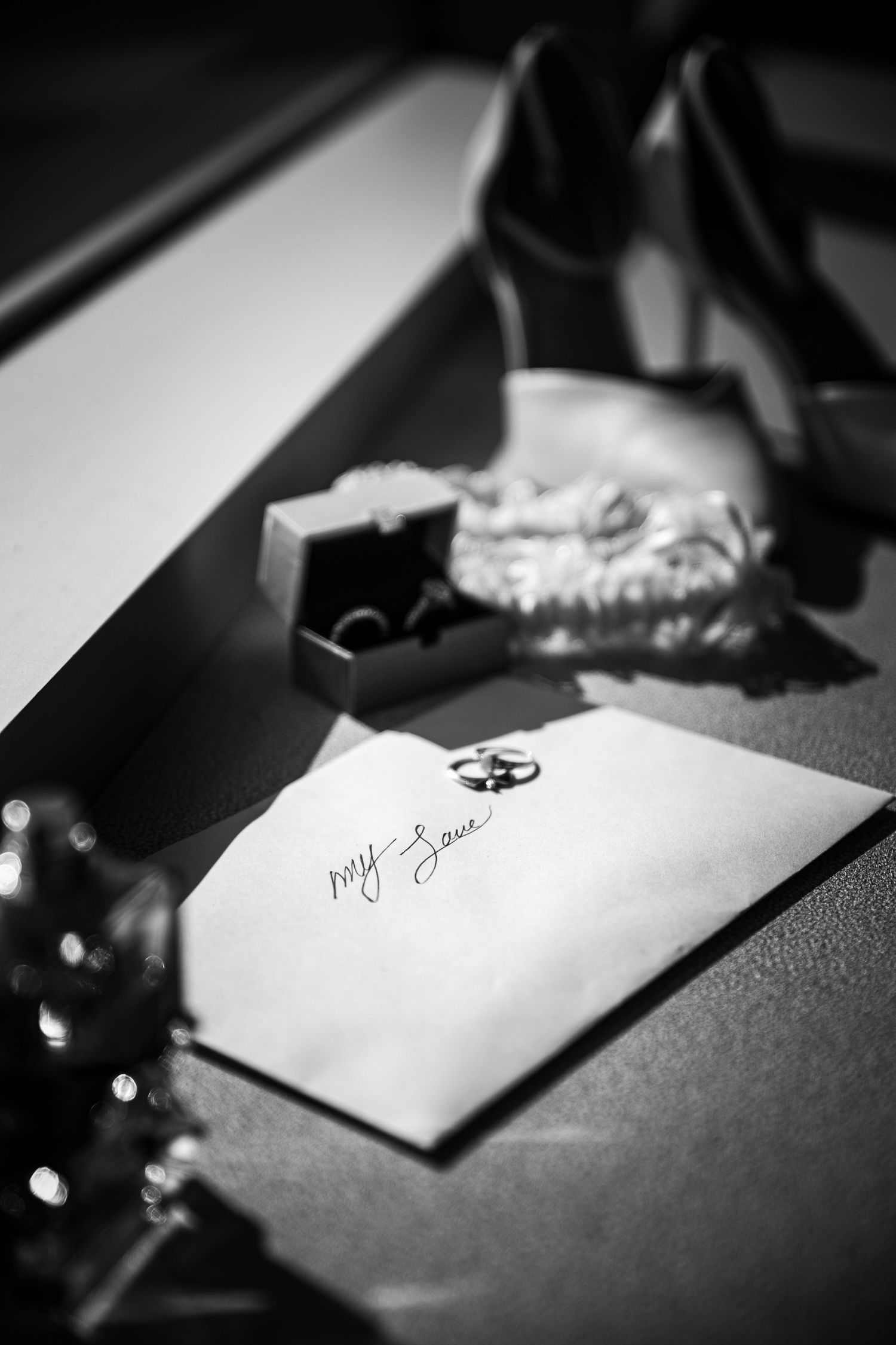 Wedding guest signature book with pen in dramatic black and white lighting.