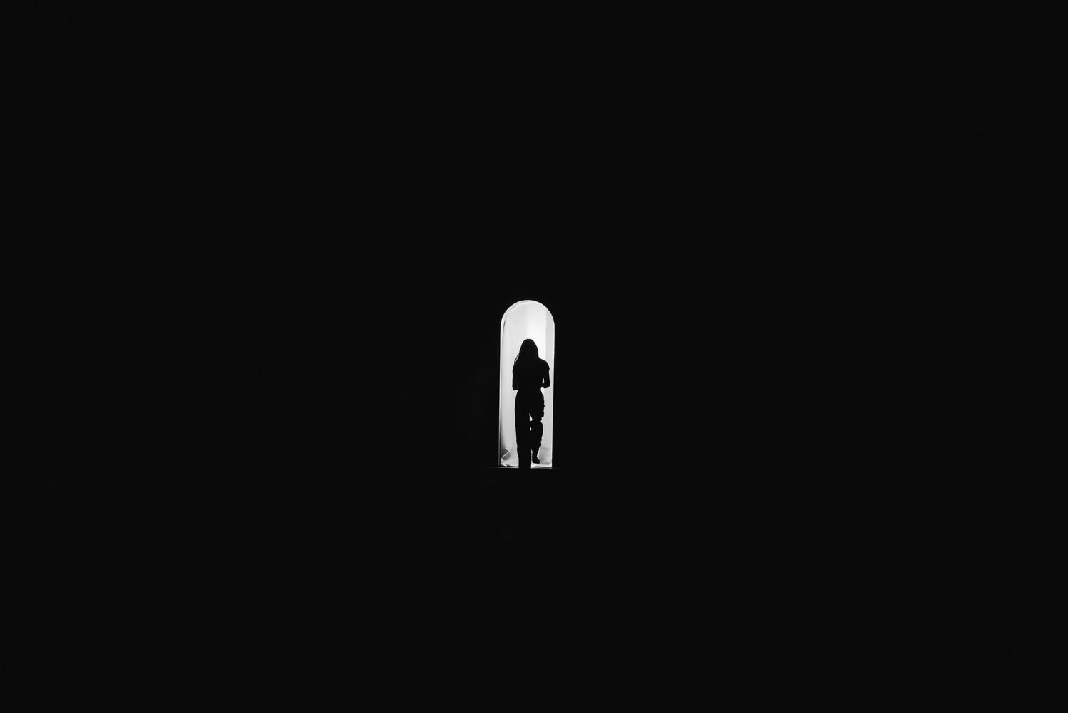 Dark minimalist photography backdrop with dramatic lighting setup.