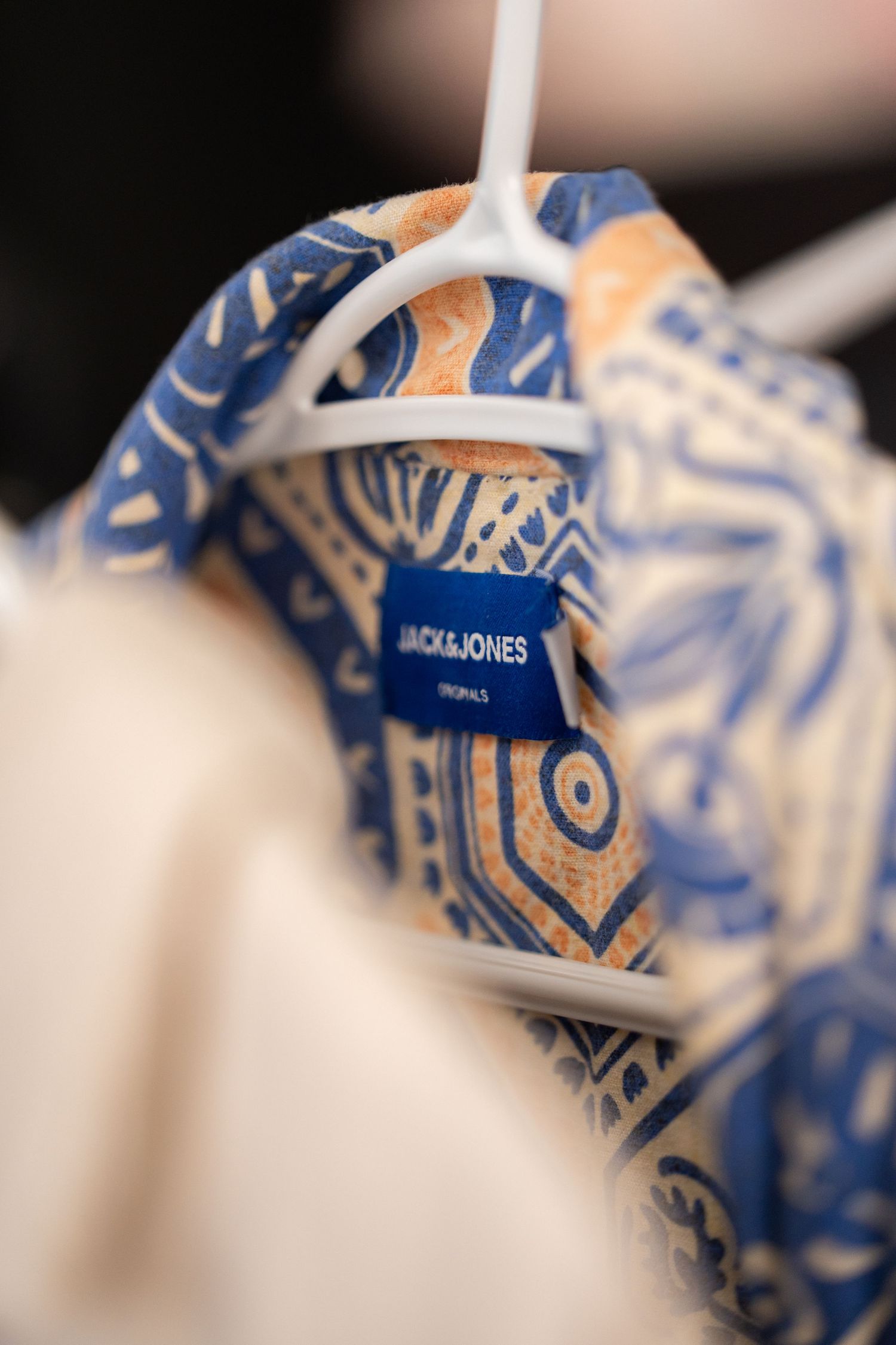 Close-up of blue and white Jack & Jones clothing tags in a row.