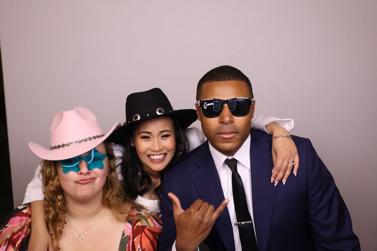 Wedding guests with the bride posing for photo booth pictures
