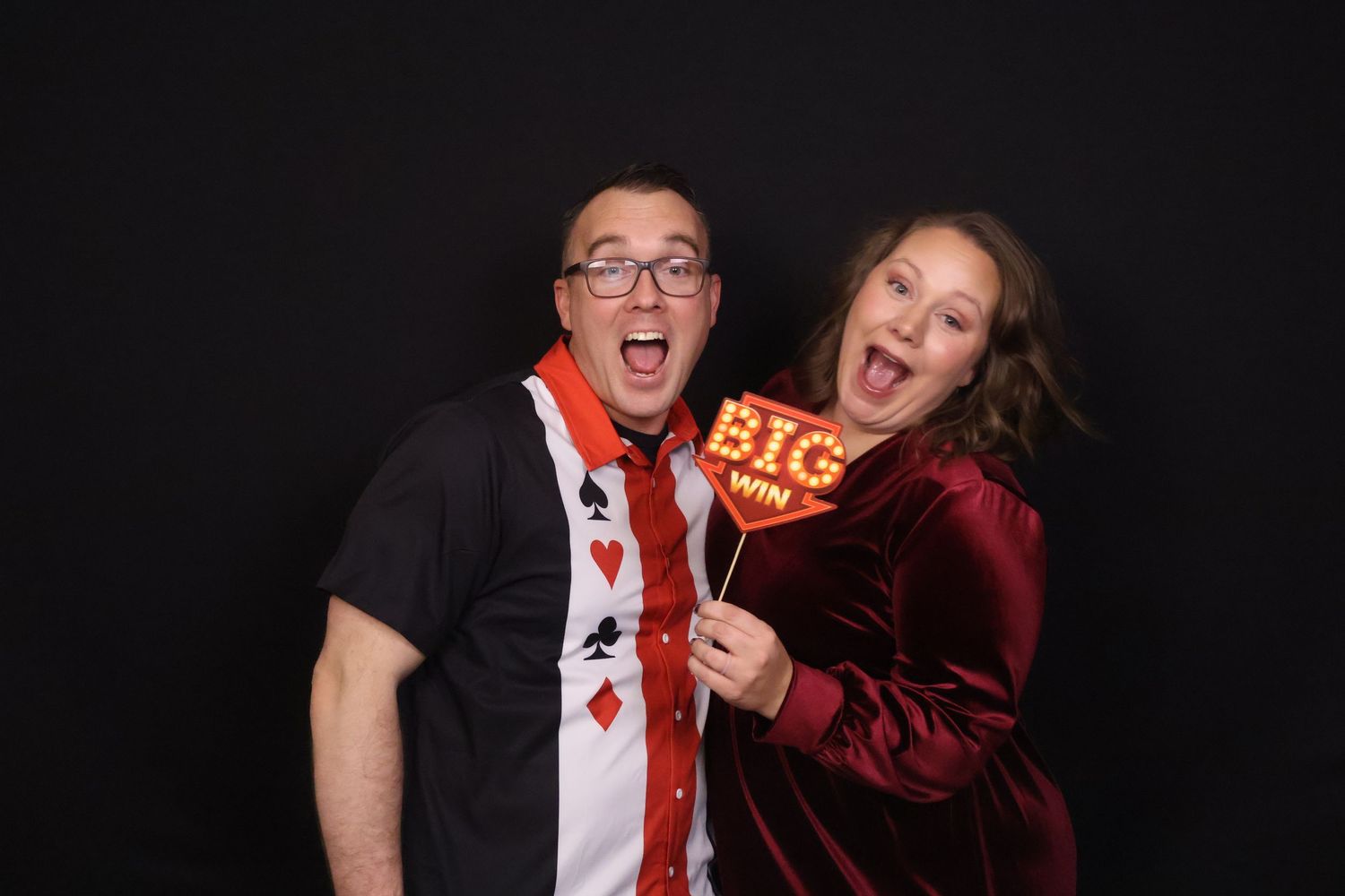 Guests making silly faces while posing with props for a holiday event