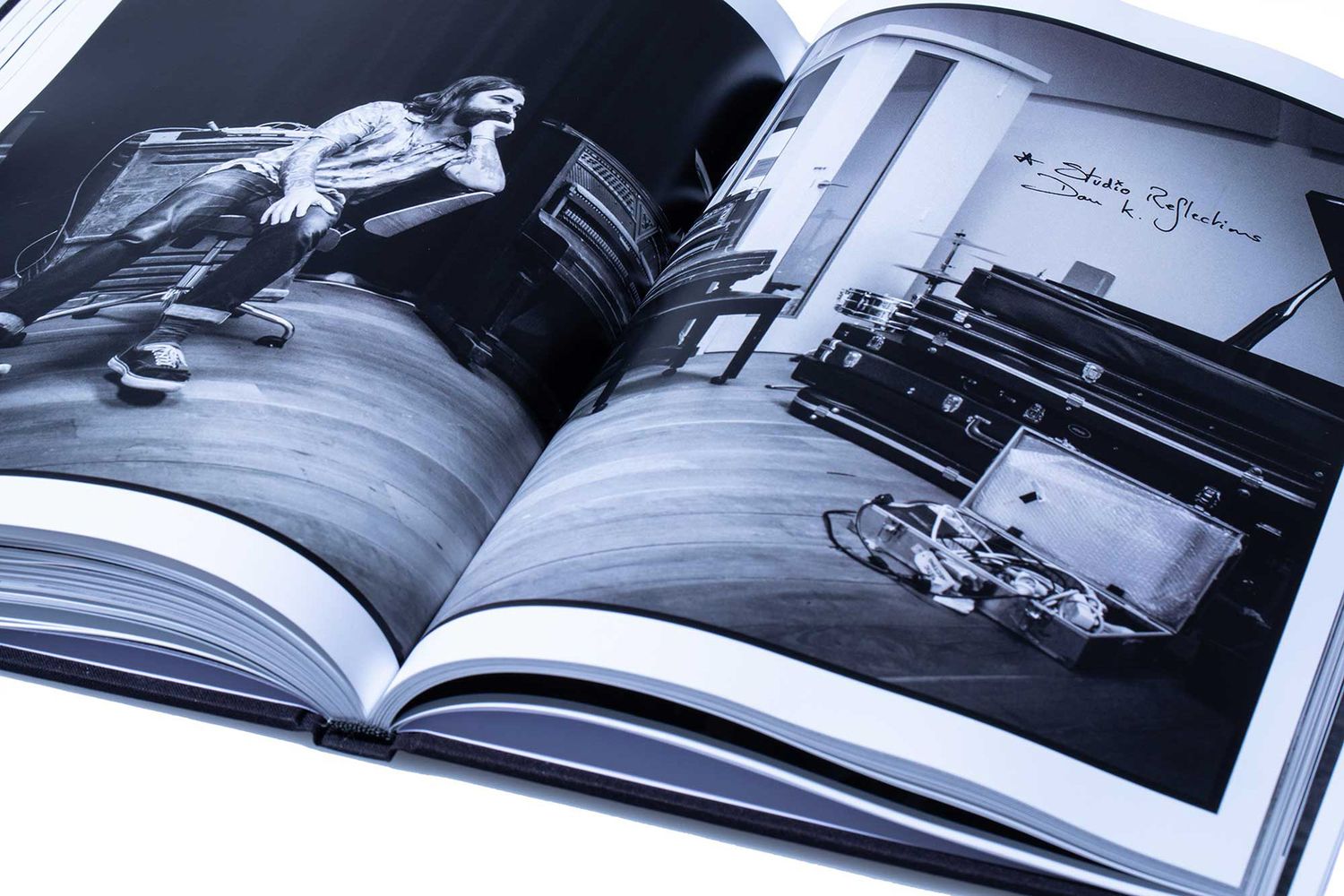 Open book displaying black and white photography spread with artistic portraits.