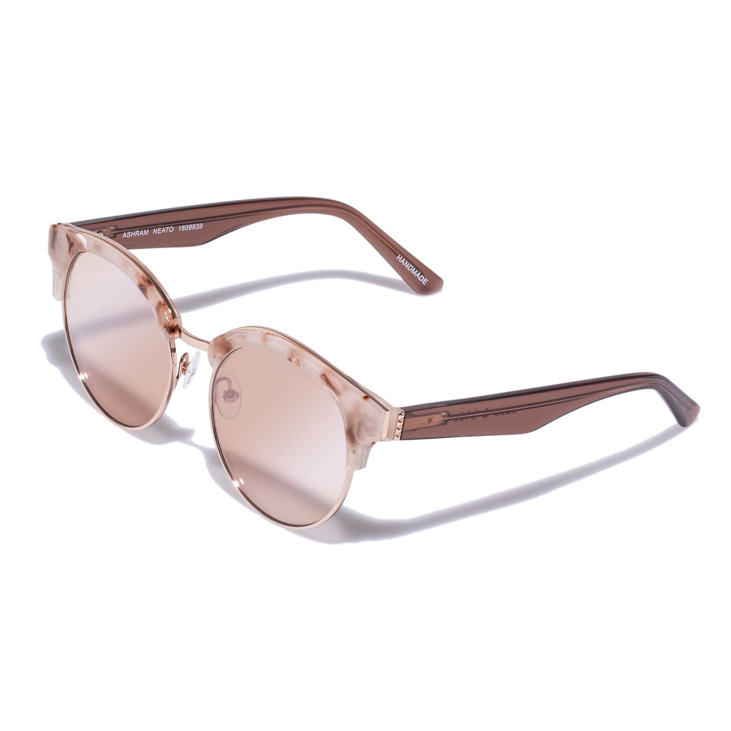 Rose gold round sunglasses with gradient pink lenses and transparent brown frames on white background.