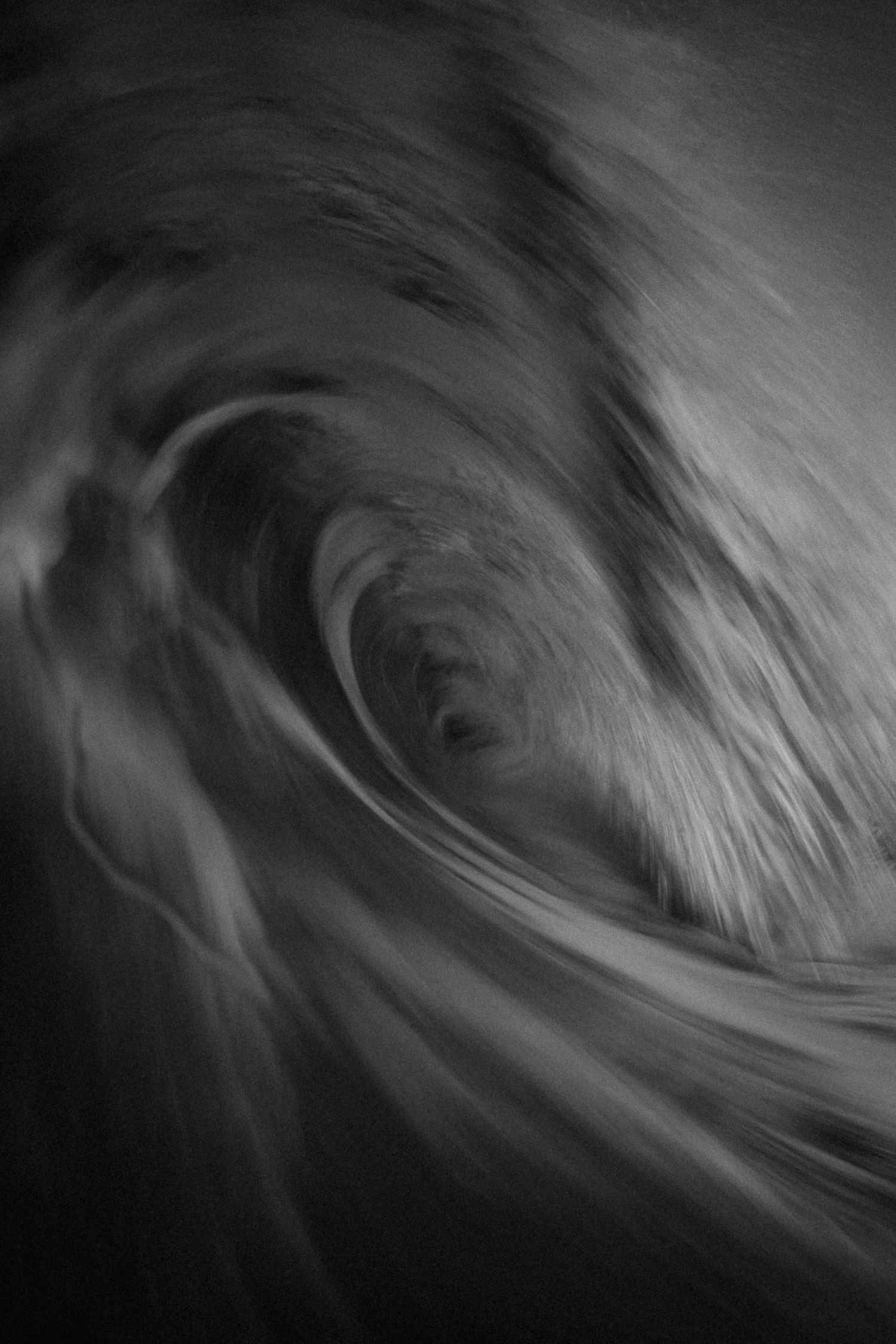 Abstract black and white swirling motion blur wave photography art.