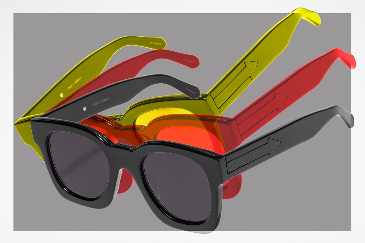 Stackable interchangeable sunglasses frames in black yellow and red with dark lenses on gray background.