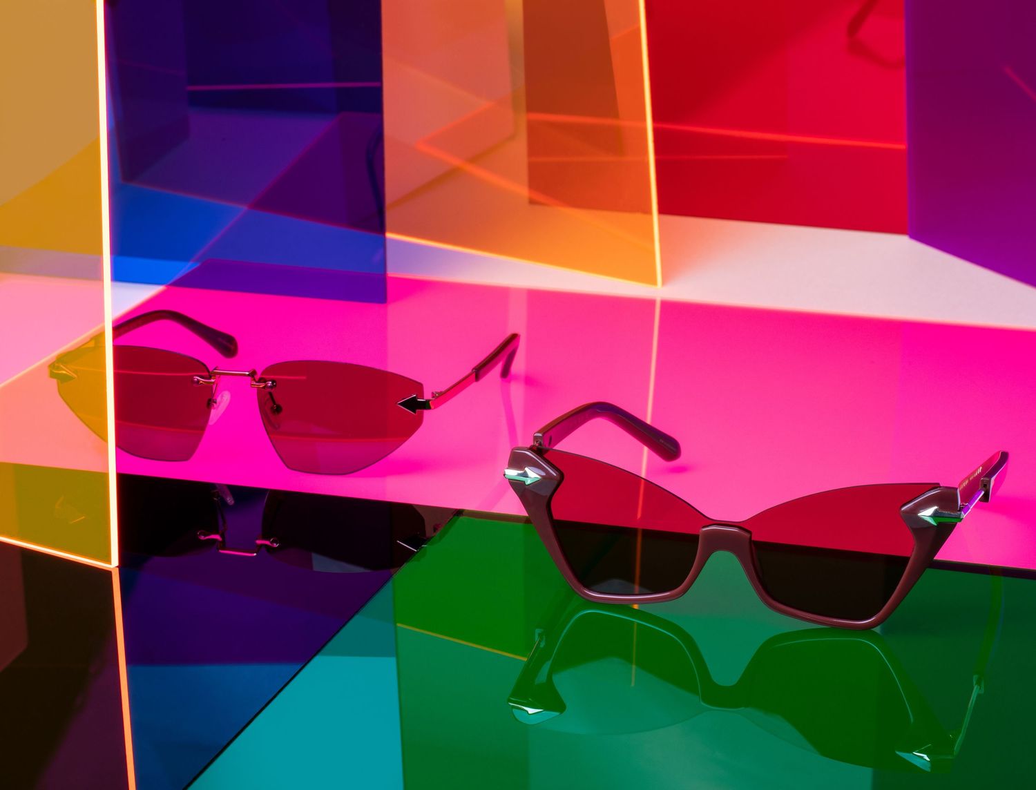 Elegant rimless cat-eye sunglasses with rose gold mirrored lenses on white background.