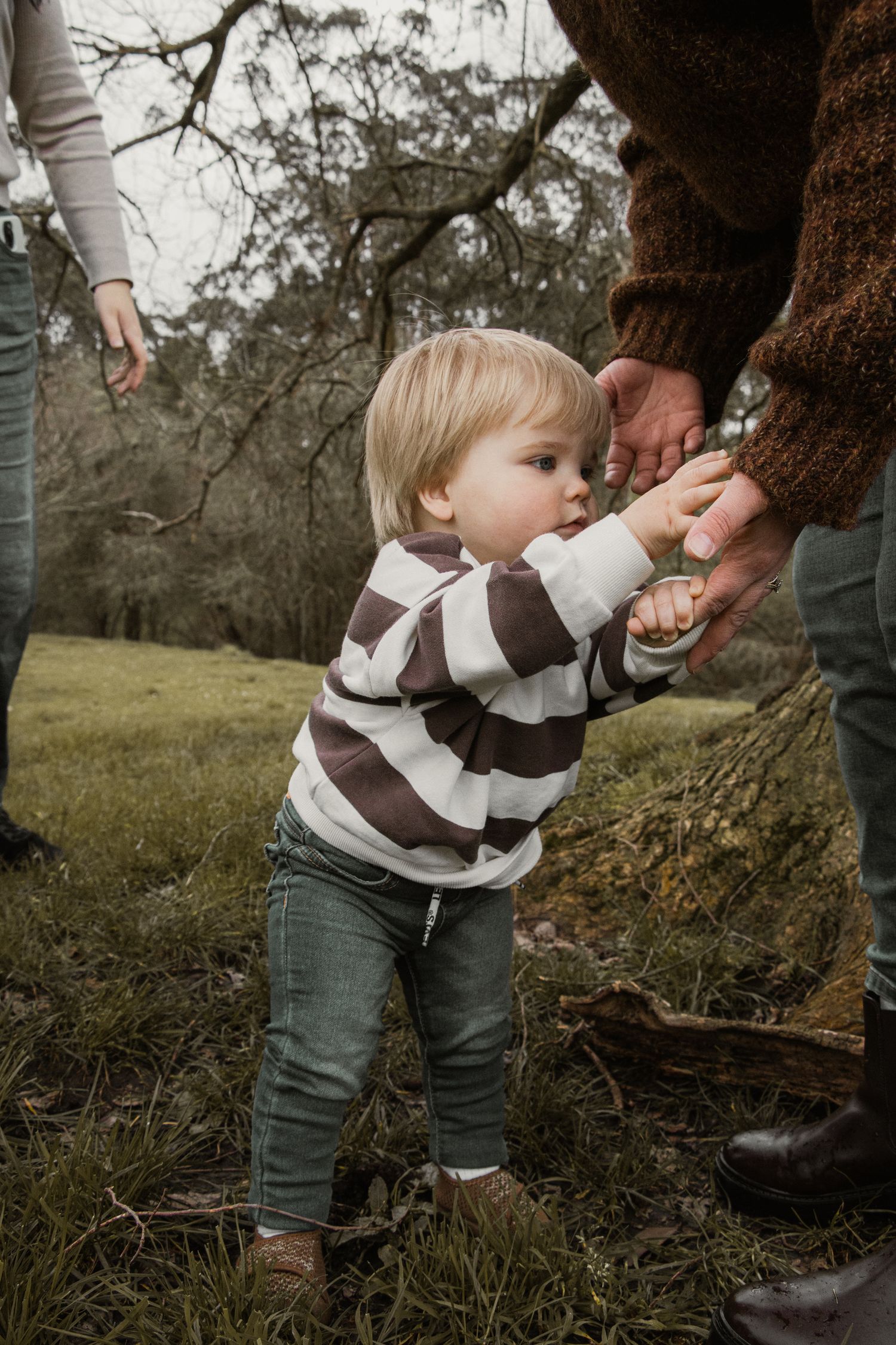 Toddler Standing with mums help,  in the afternoon at lifestyle family photography session in Trafalgar, West Gippsland.