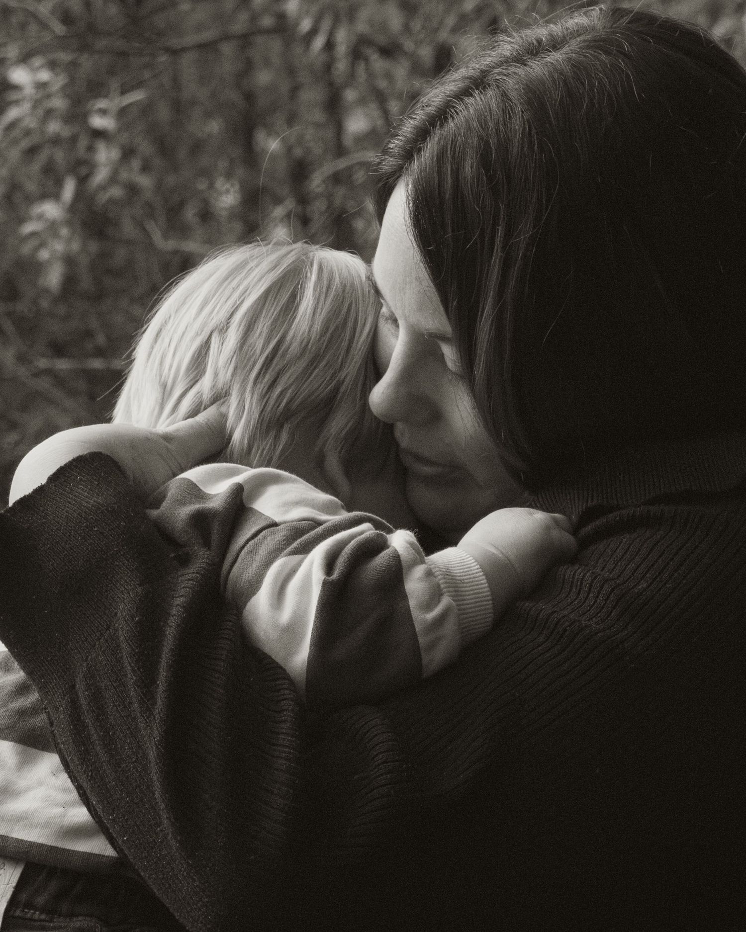 Mother slowing down cuddling toddler, in the morning at lifestyle motherhood photo session in the outdoors in Trafalgar, West Gippsland.