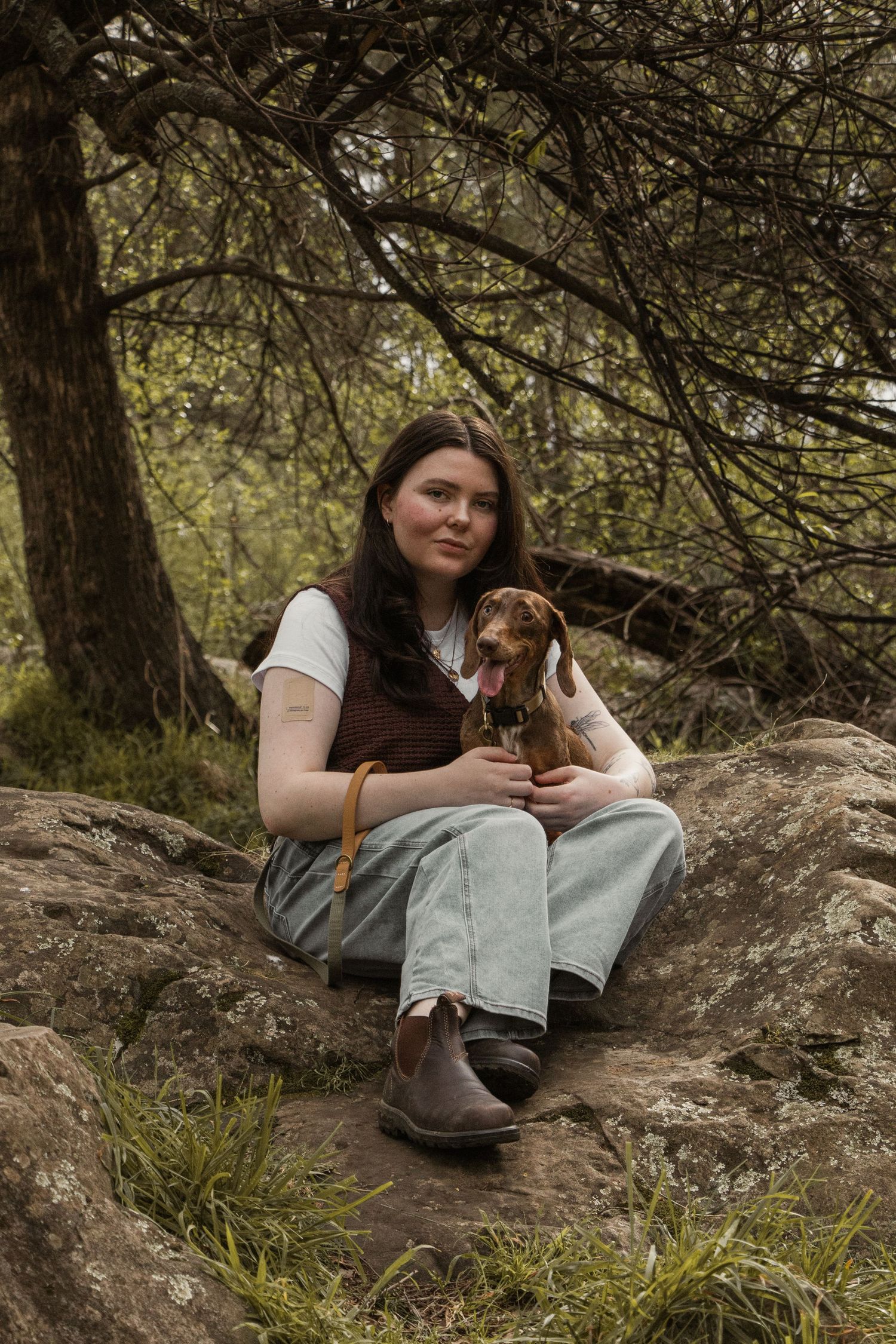 Dog owner and dog sitting outdoors, in the afternoon during lifestyle pet photo session in the outdoors in Trafalgar, West Gippsland.