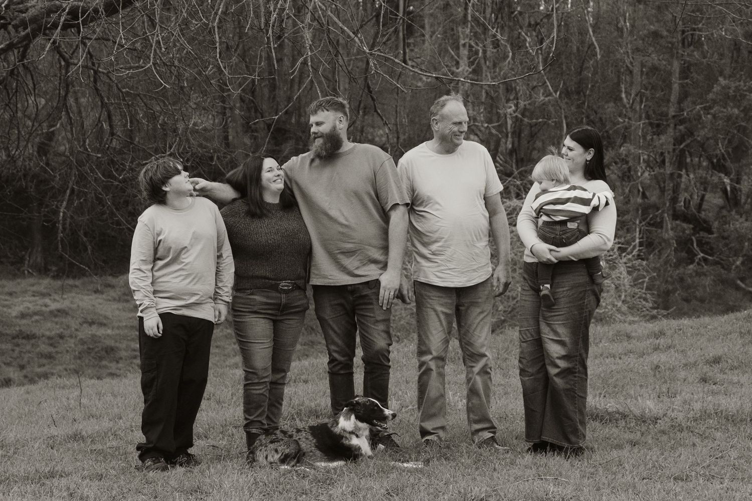 Extended Family standing looking at each other,  in the afternoon at lifestyle family photography session in Trafalgar, West Gippsland.