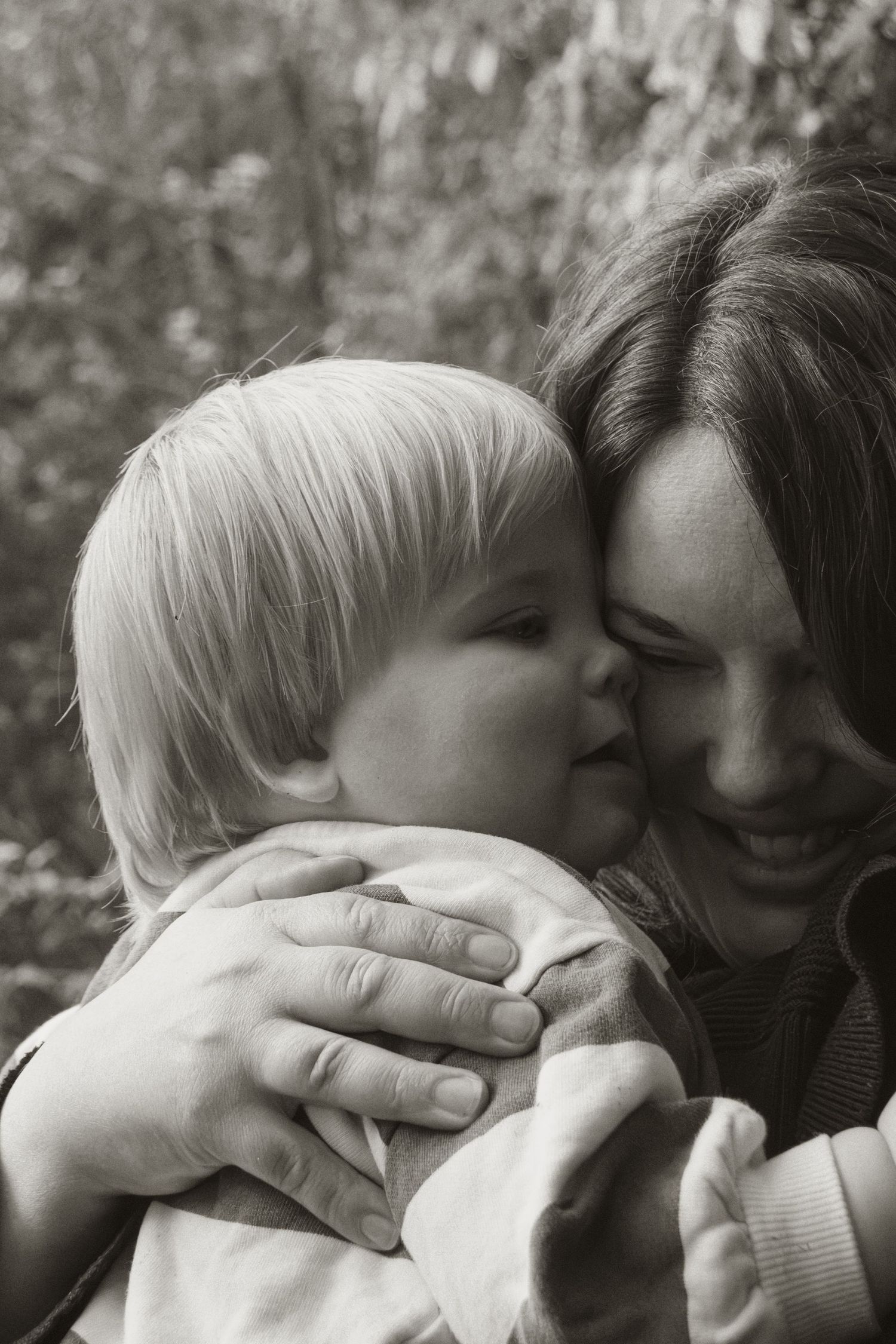 A child and mum cuddling and smiling at Uralla reserve in the outdoors in central Gippsland. Taken for a motherhood session.