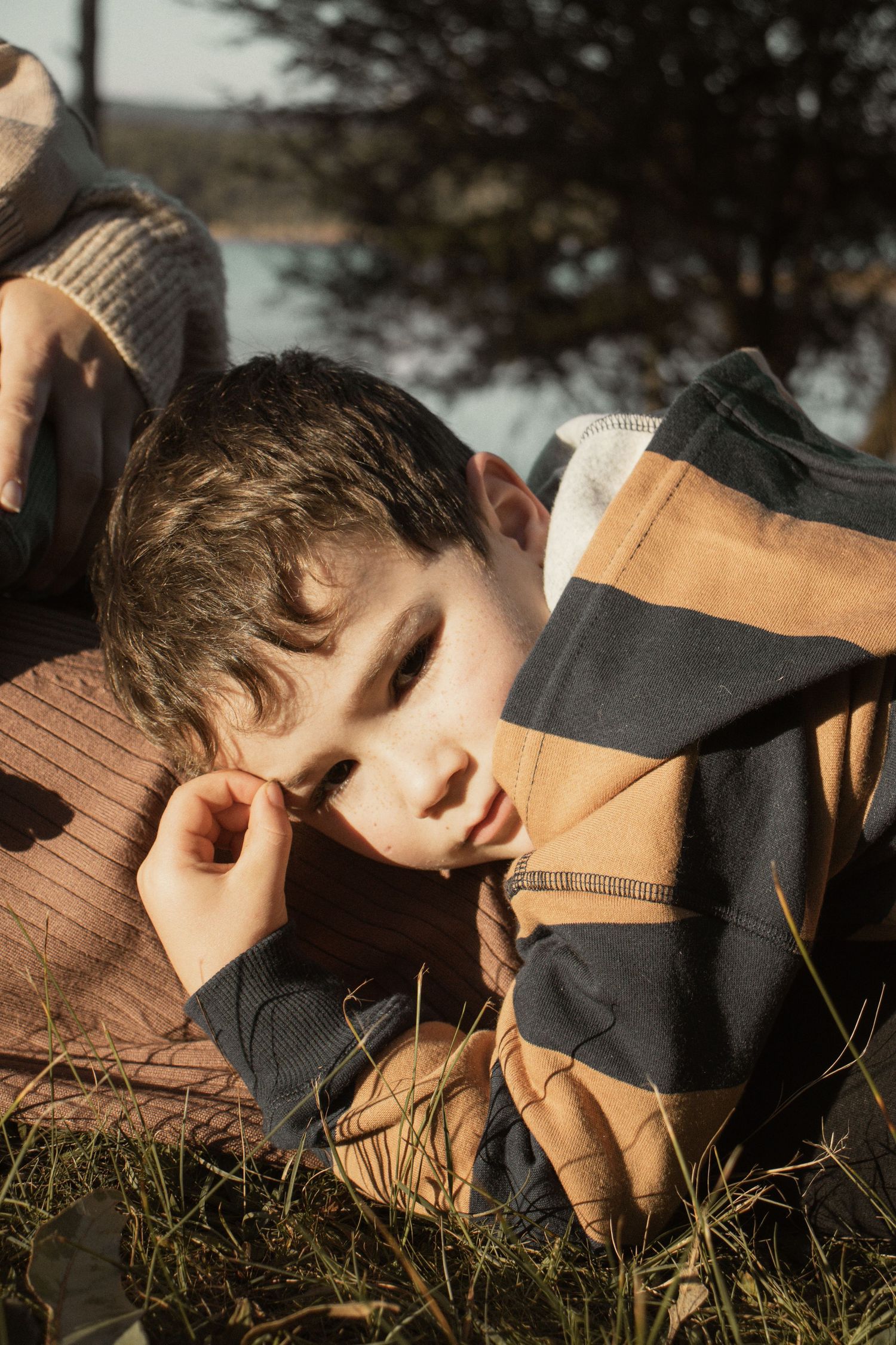 A child at blue rock lake with family in the outdoors in central Gippsland. Taken for a motherhood/pet session.