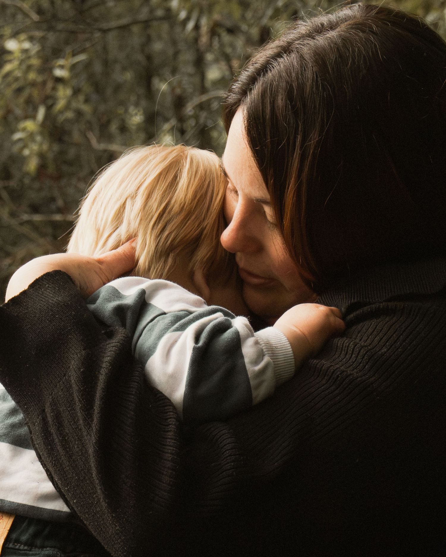 A child and mum cuddling at Uralla reserve in the outdoors in central Gippsland. Taken for a motherhood session.