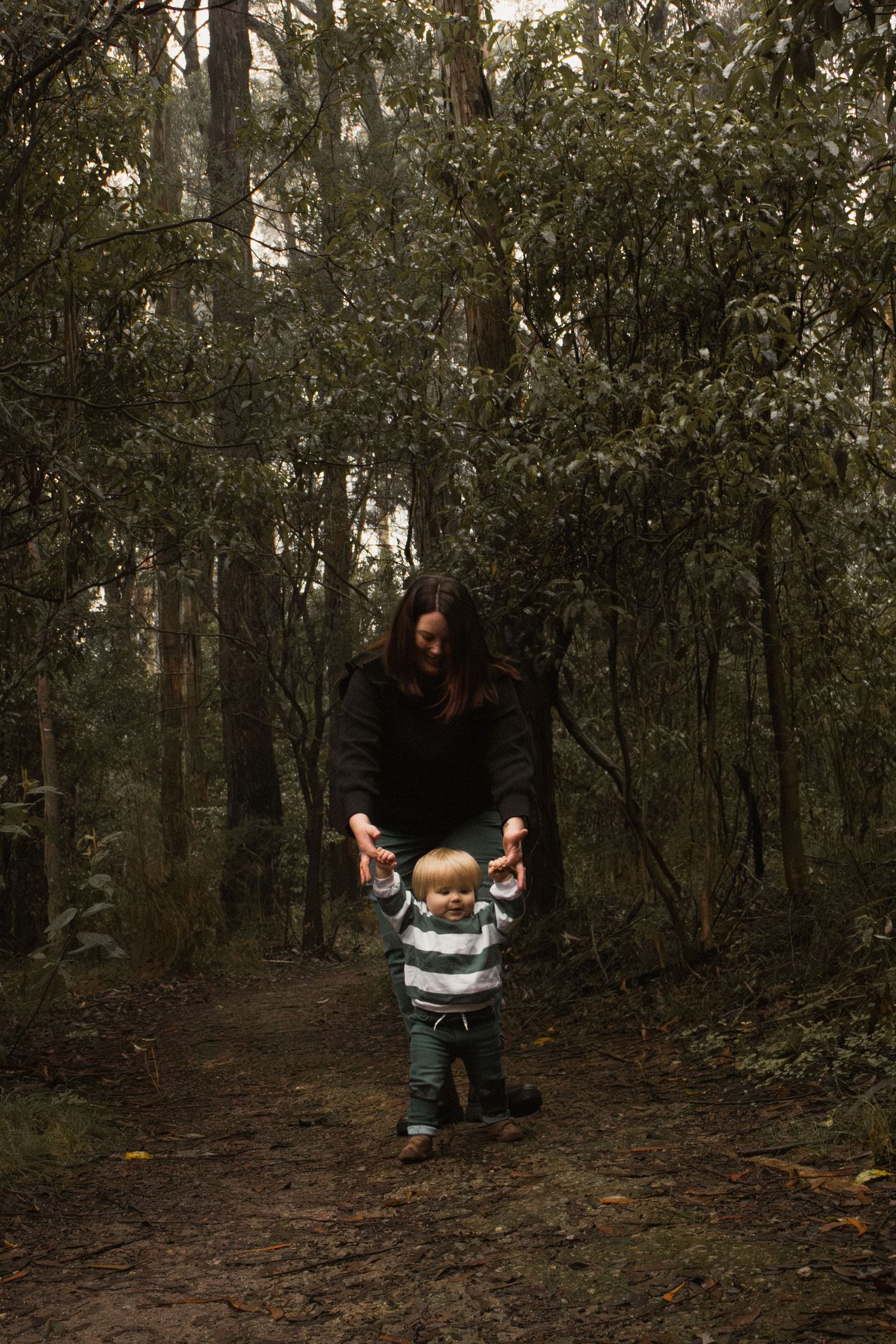 A mother walking with son in the forest, on a hiking trail outdoors in central Gippsland. Taken for a motherhood session.