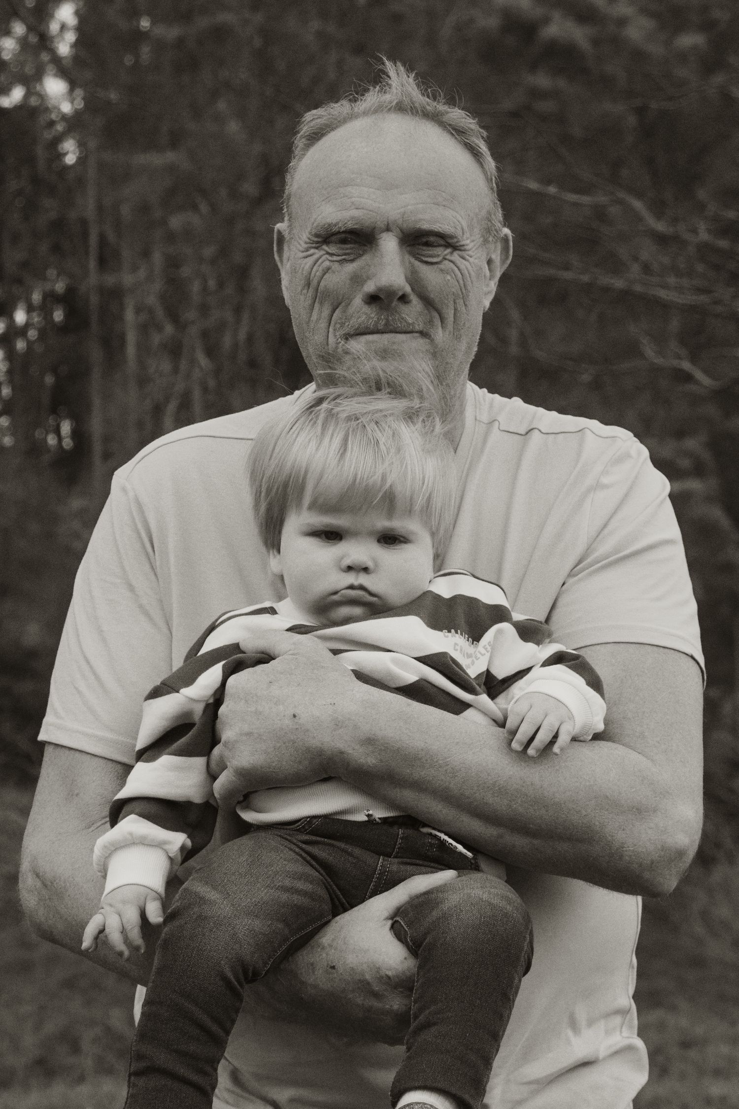Grandpa holding grandson in arms, in the afternoon at lifestyle family photography session in Trafalgar, West Gippsland.
