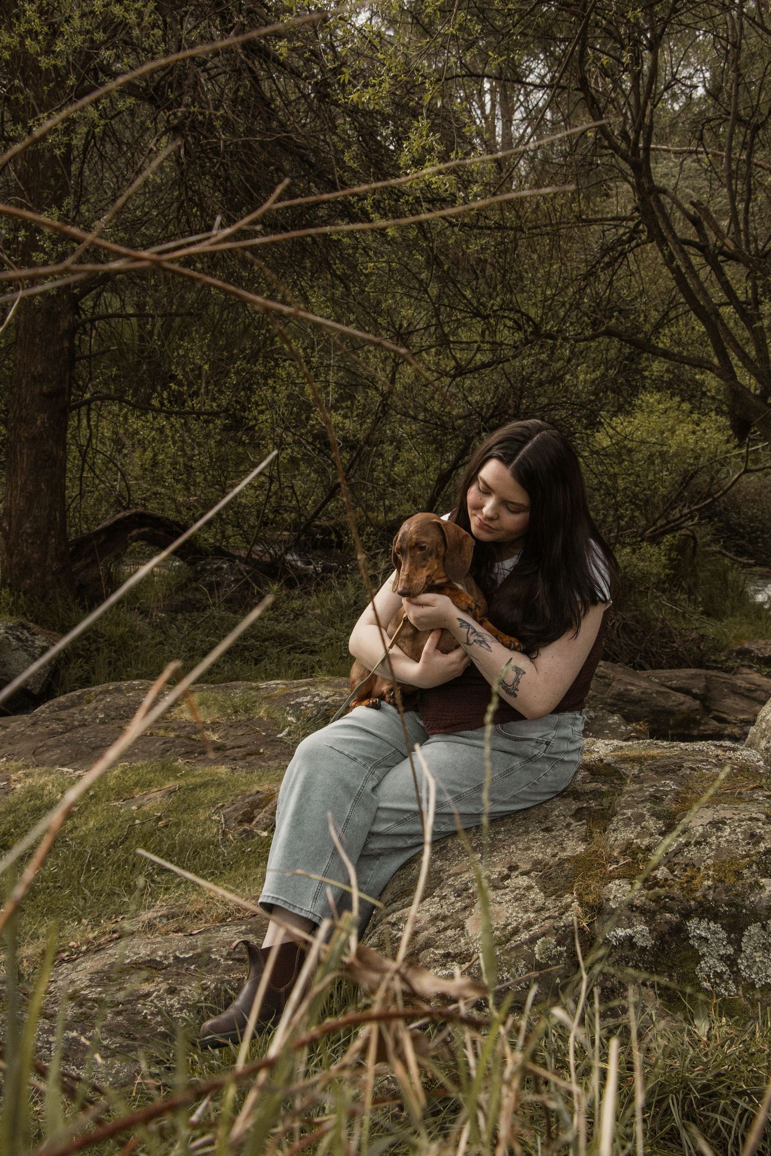 Pet owner and dog sitting candidly, in the afternoon during a pet photo session in the outdoors in Trafalgar, West Gippsland.