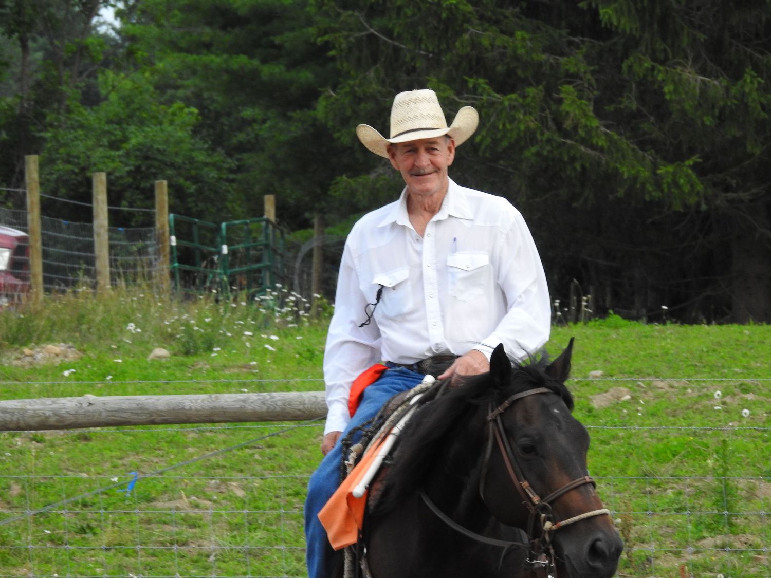 Horse riders with flags performing at outdoor equestrian event.