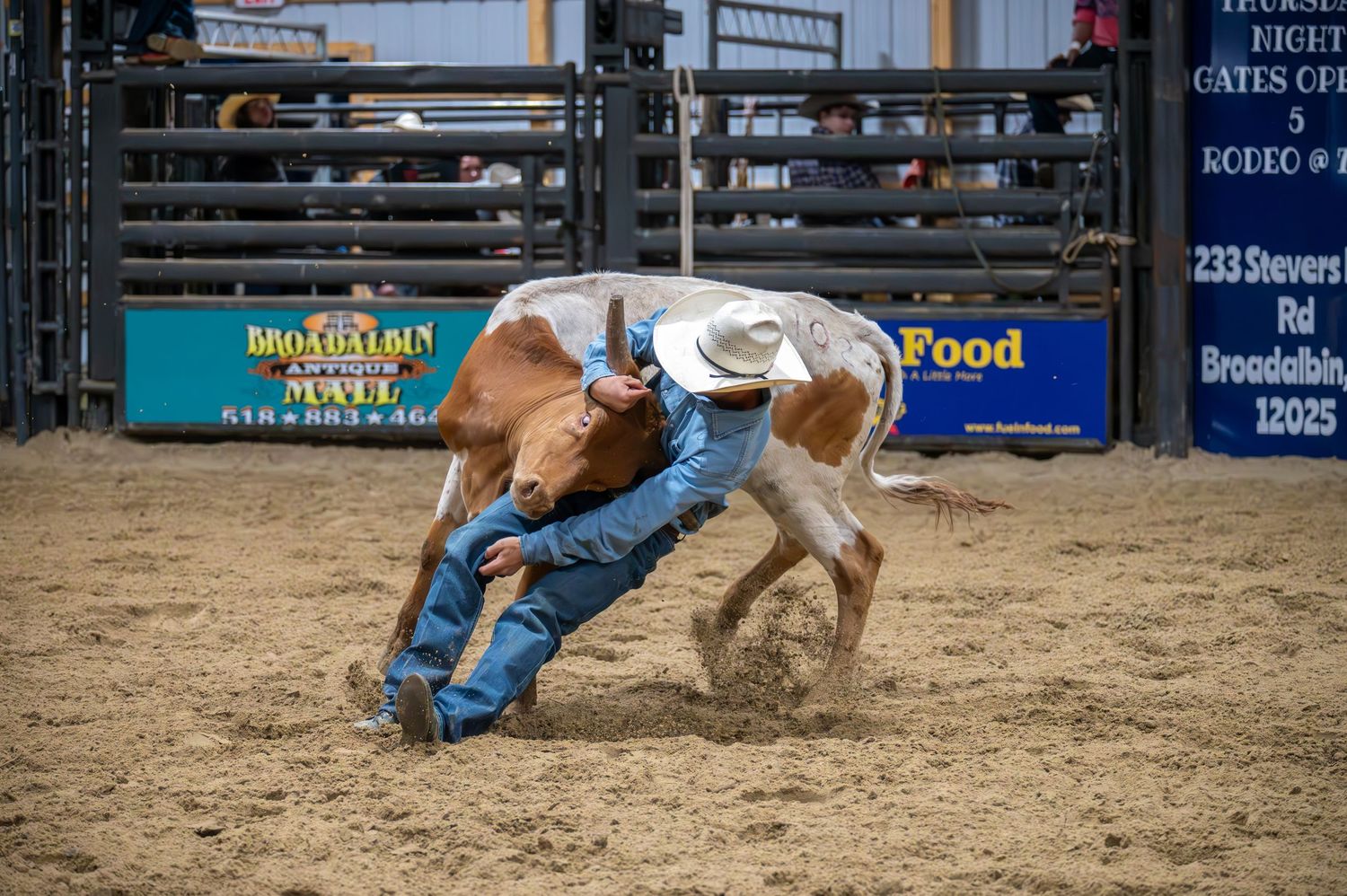 Rodeo action sequence showing horse and rider in indoor arena.