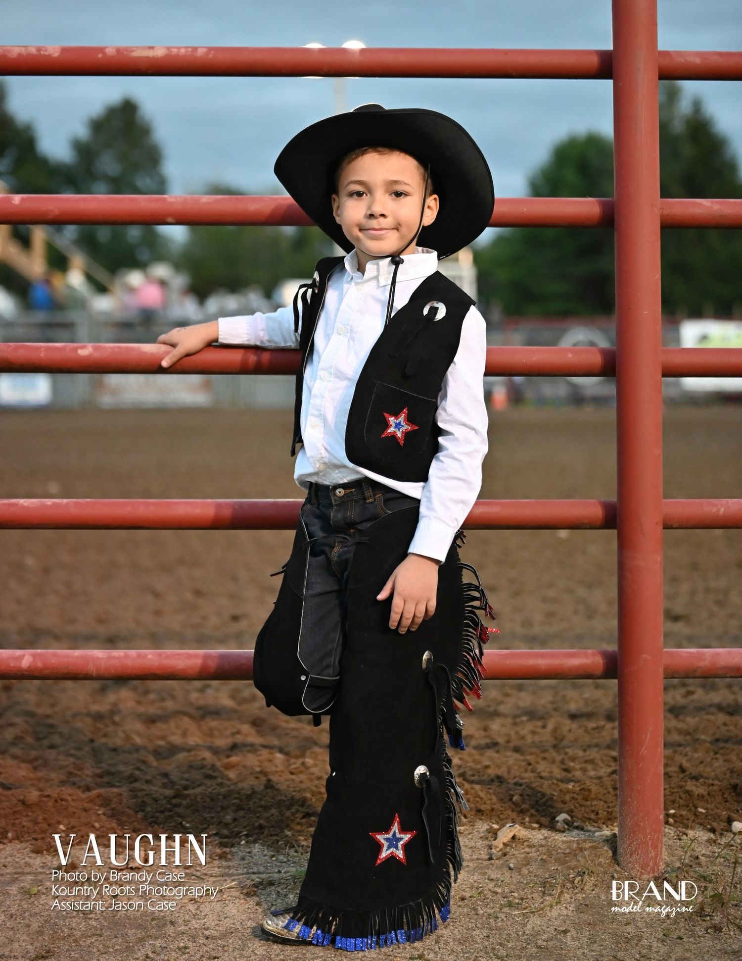 Baby photography session with cowboy boots and rustic barn wood background.