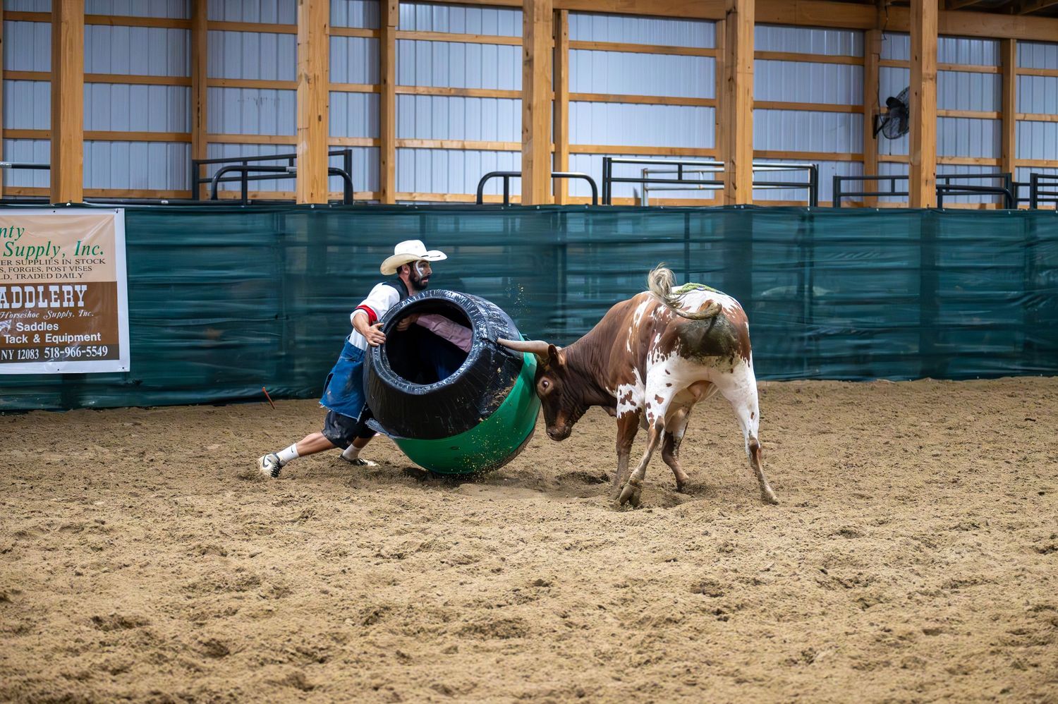 Rodeo action sequence showing riders performing stunts and tricks in a sandy arena.