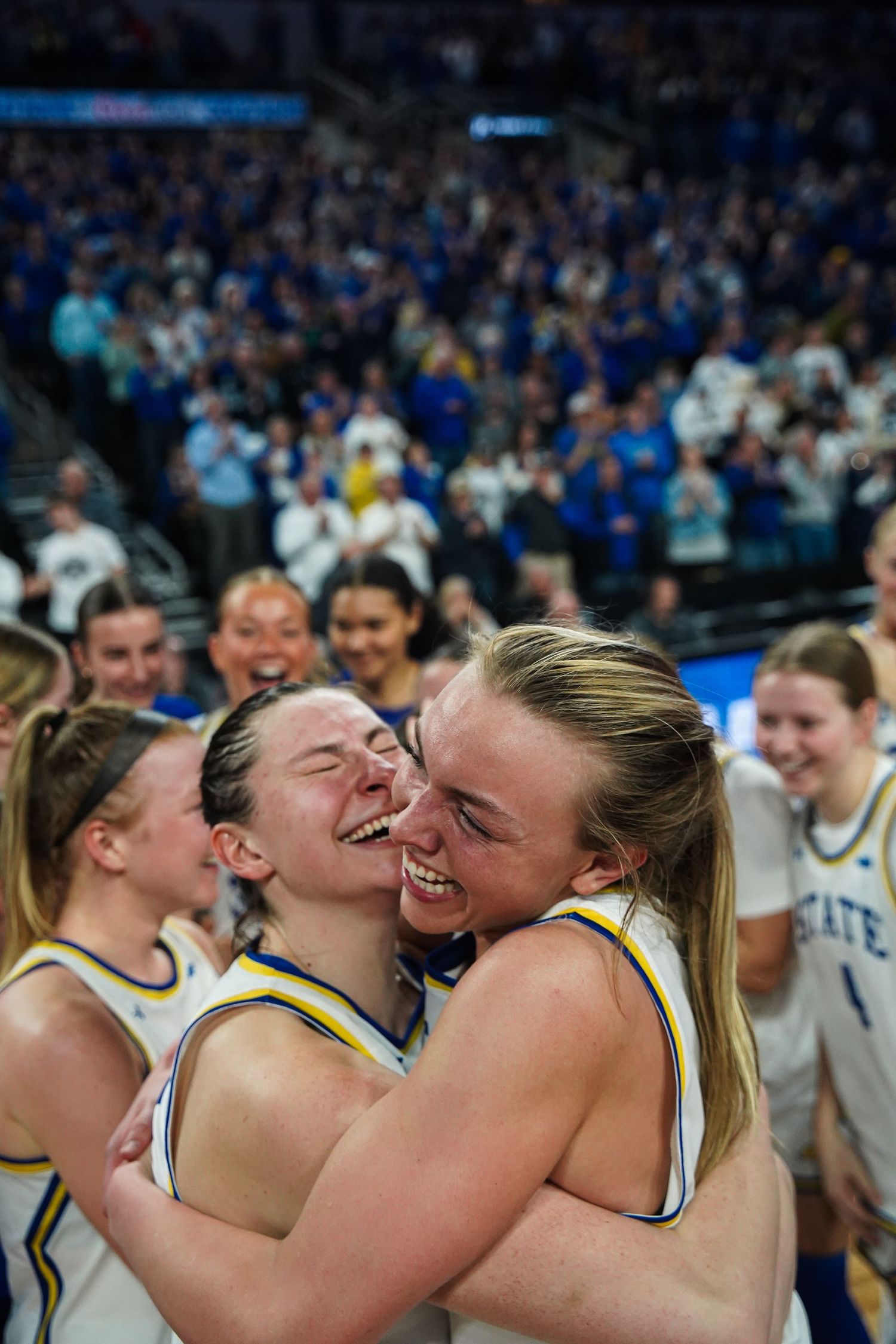 A photo of South Dakota State University women's basketball players celebrating by Evan Patzwald Media.