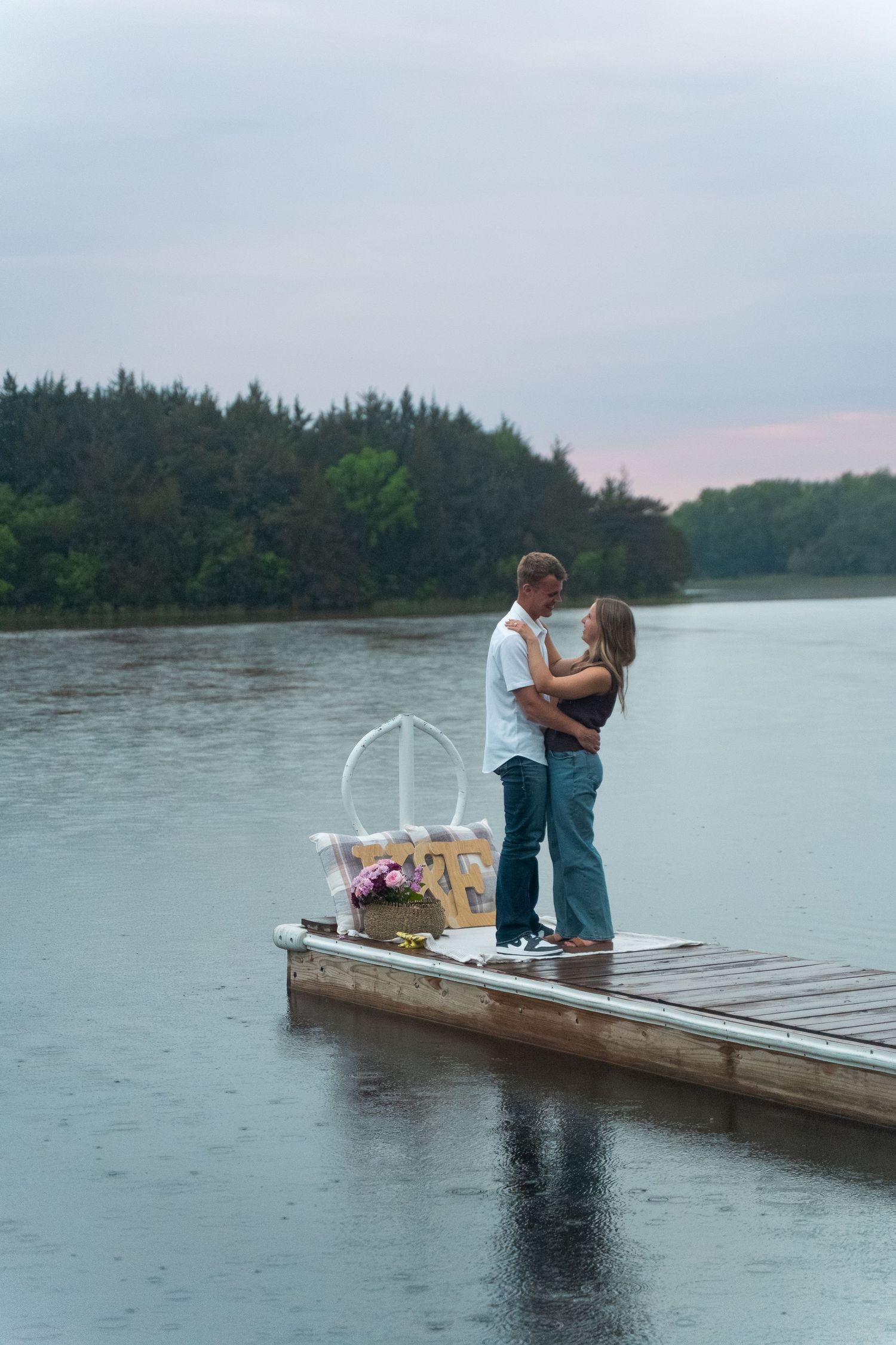 A portrait of a couple on a dock for an engagement session by Evan Patzwald Media.