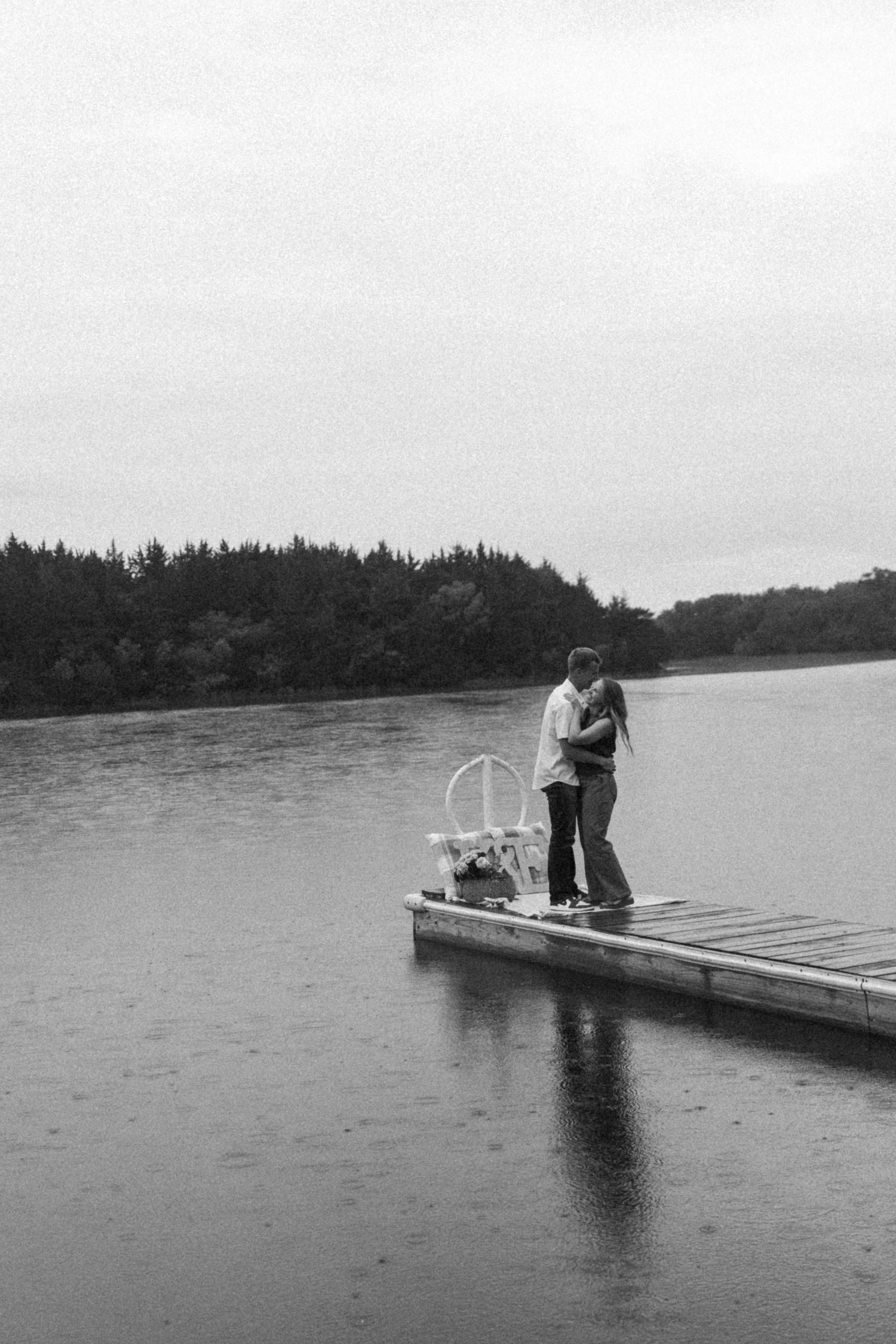 A portrait of a couple on a dock for an engagement session by Evan Patzwald Media.