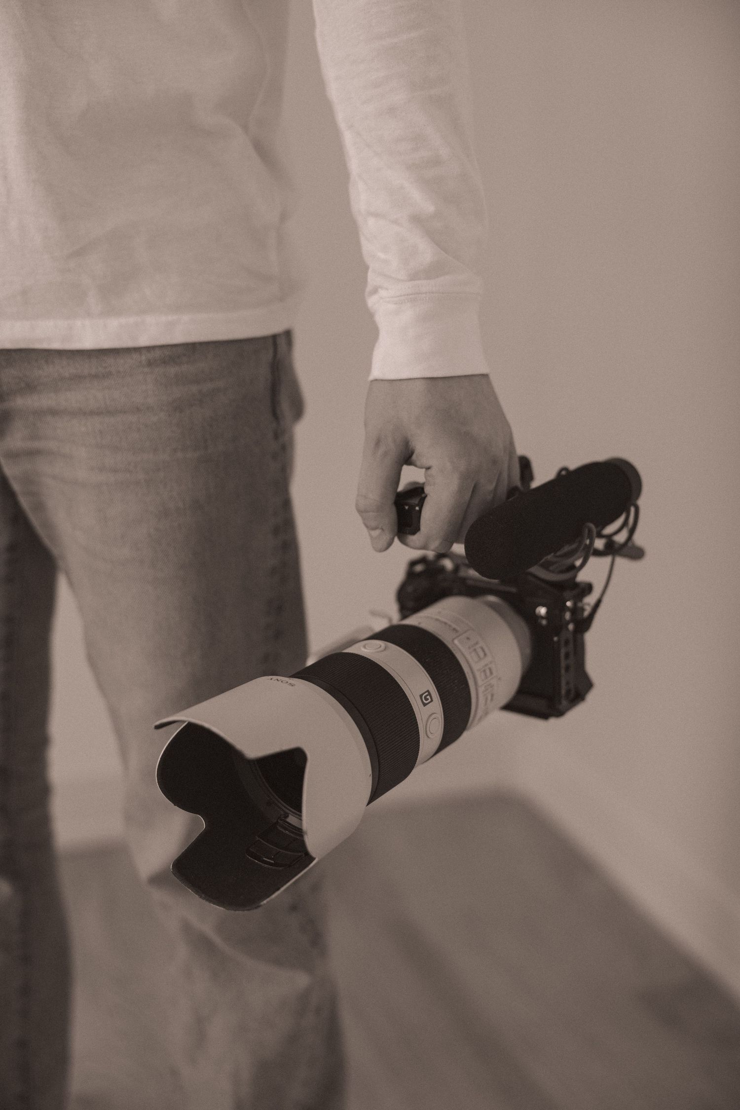 A portrait of Evan Patzwald holding a camera for Evan Patzwald Media.