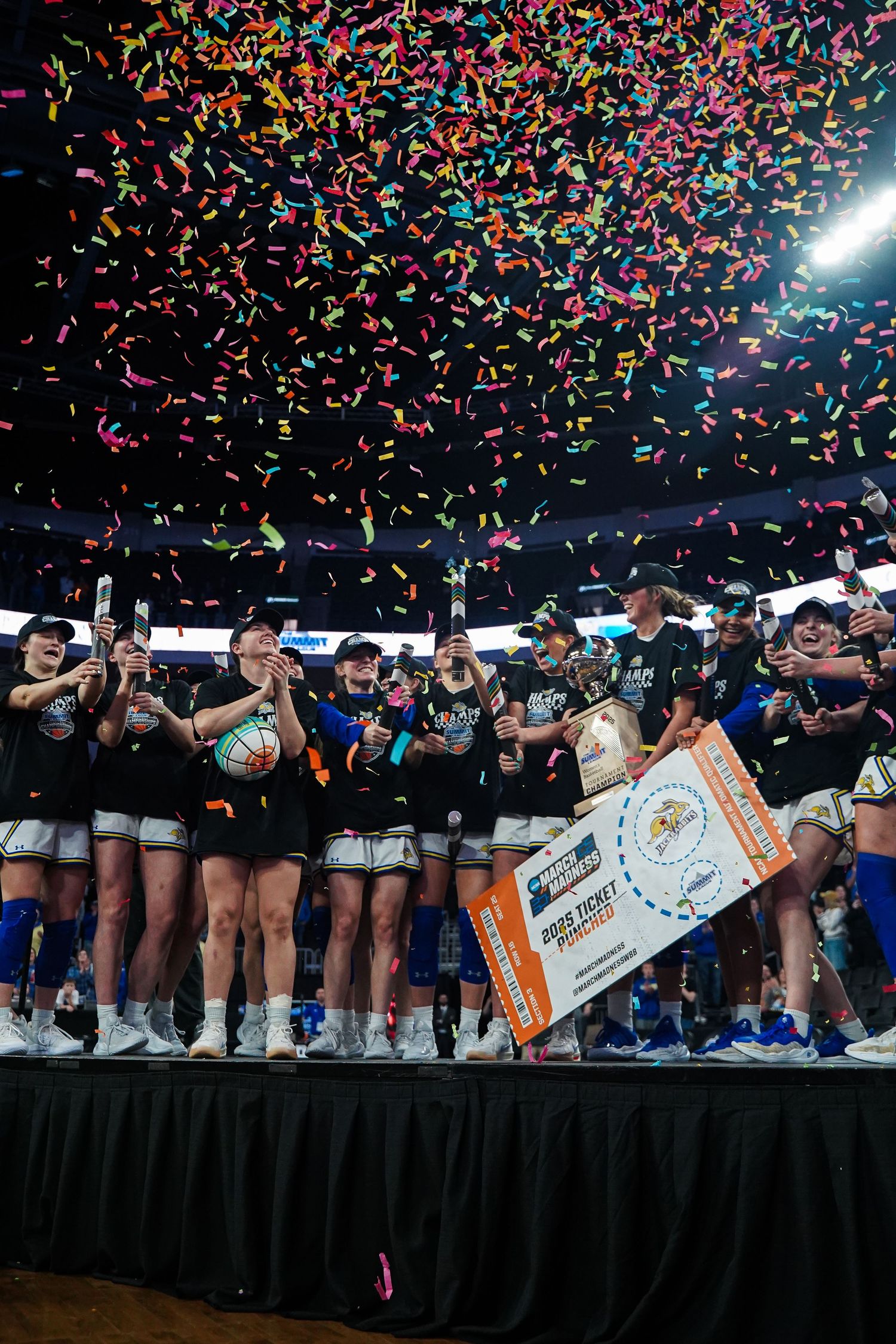 A photo of South Dakota State University women's basketball players celebrating by Evan Patzwald Media.