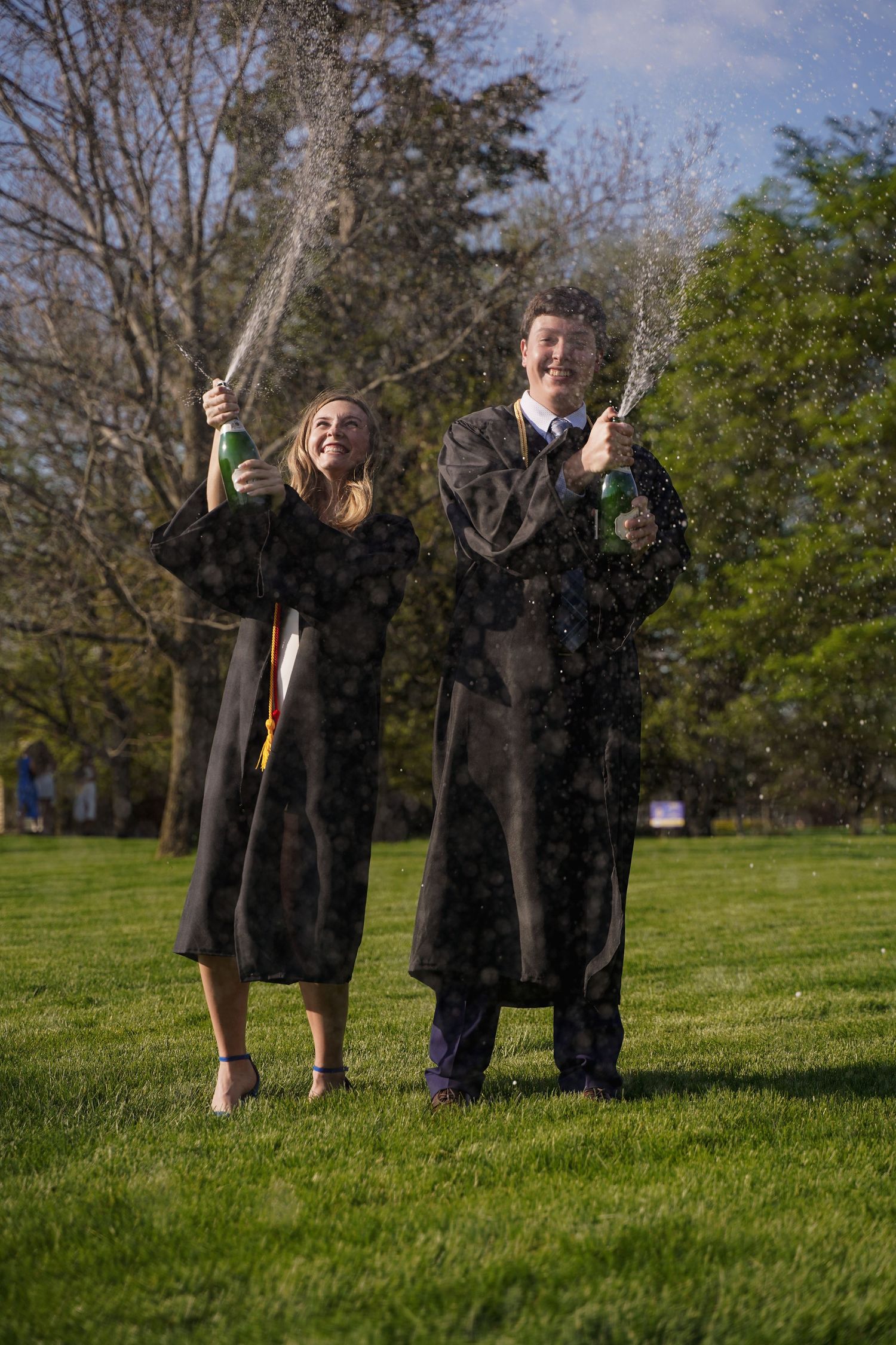A portrait of a couple popping champagne by Evan Patzwald Media.