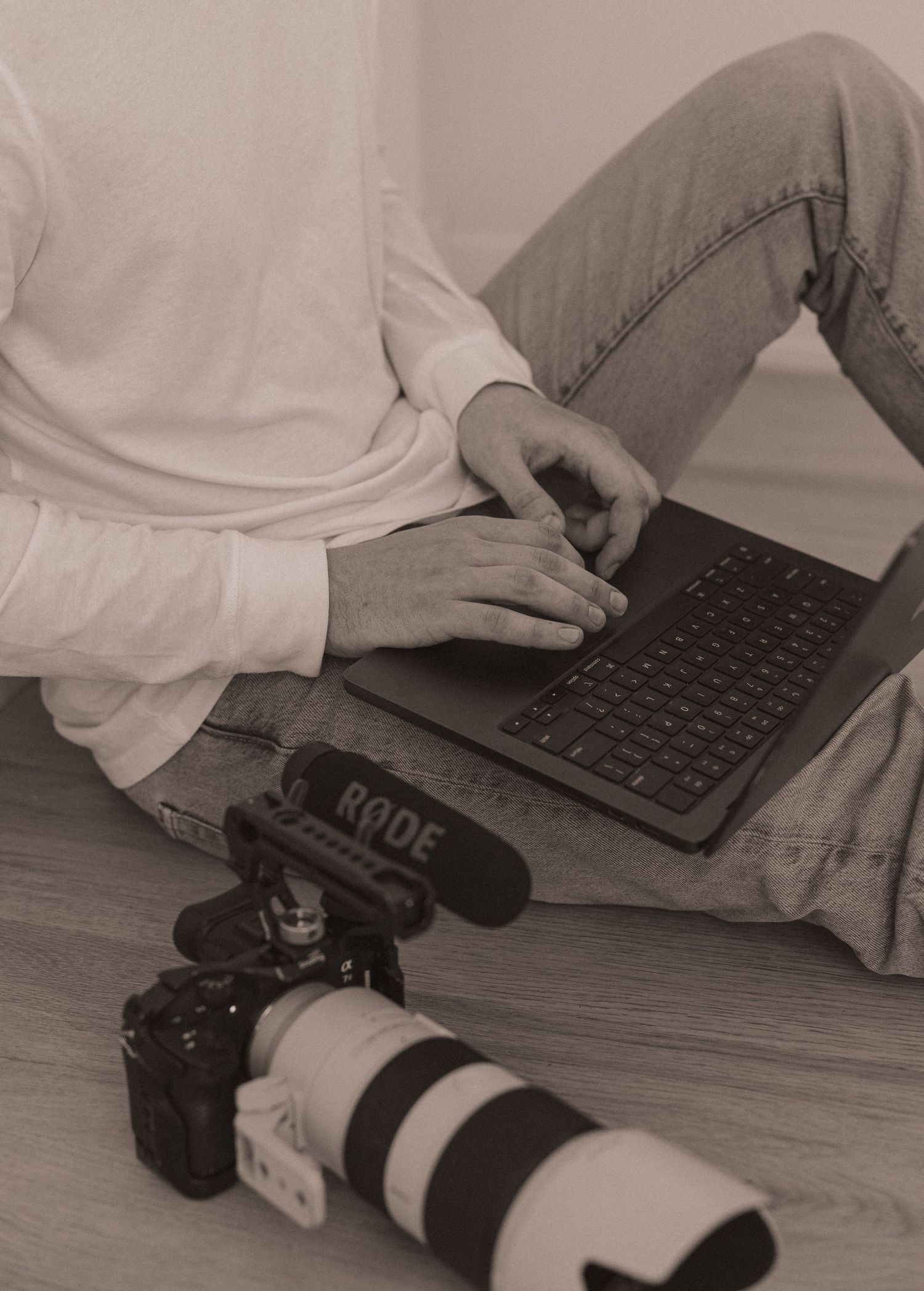 A portrait of Evan Patzwald holding a laptop for Evan Patzwald Media.