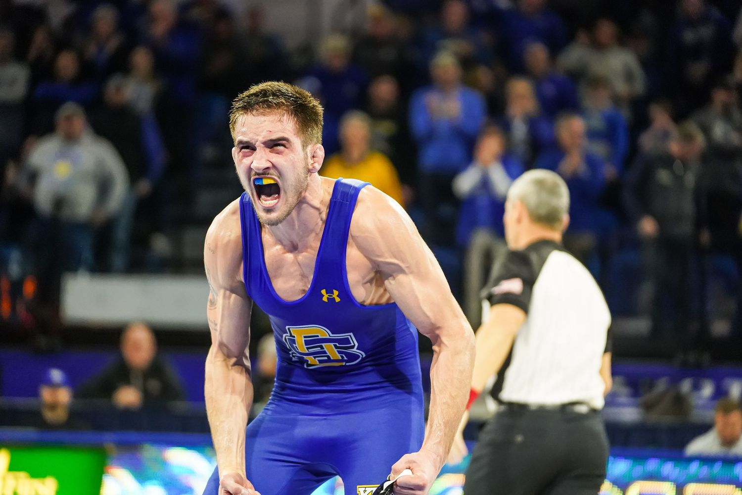 A photo of a South Dakota State University wrestler flexing by Evan Patzwald Media.