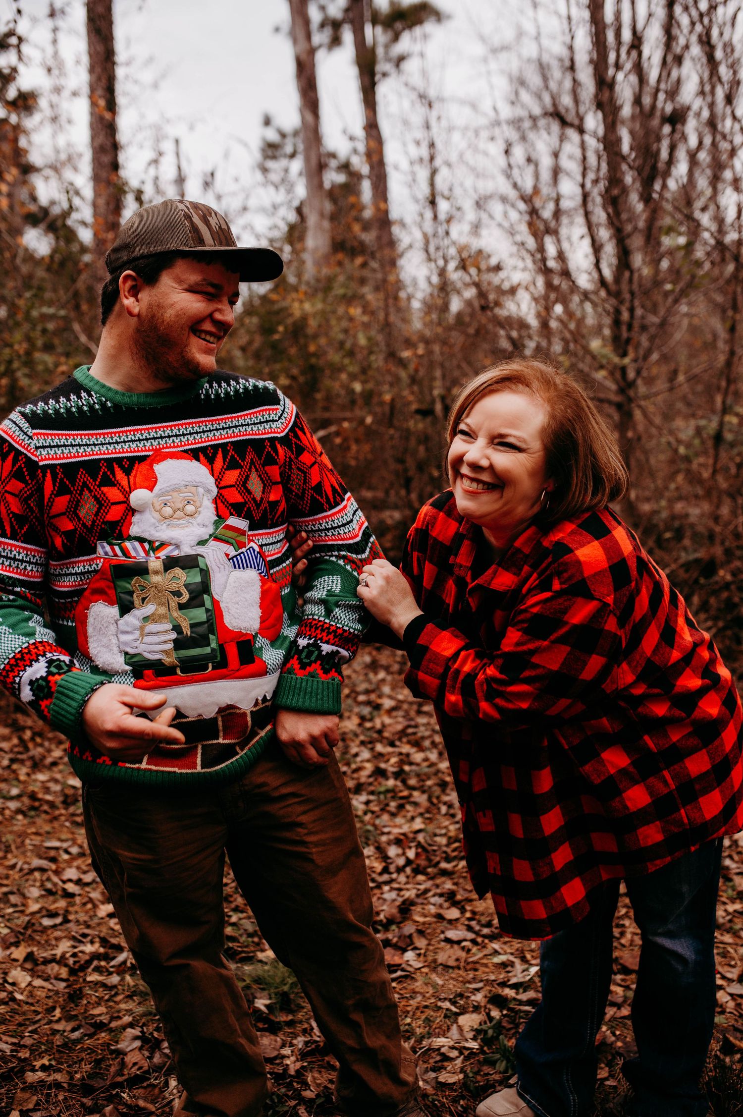 Woman and son laughing together in Christmas colored attire.