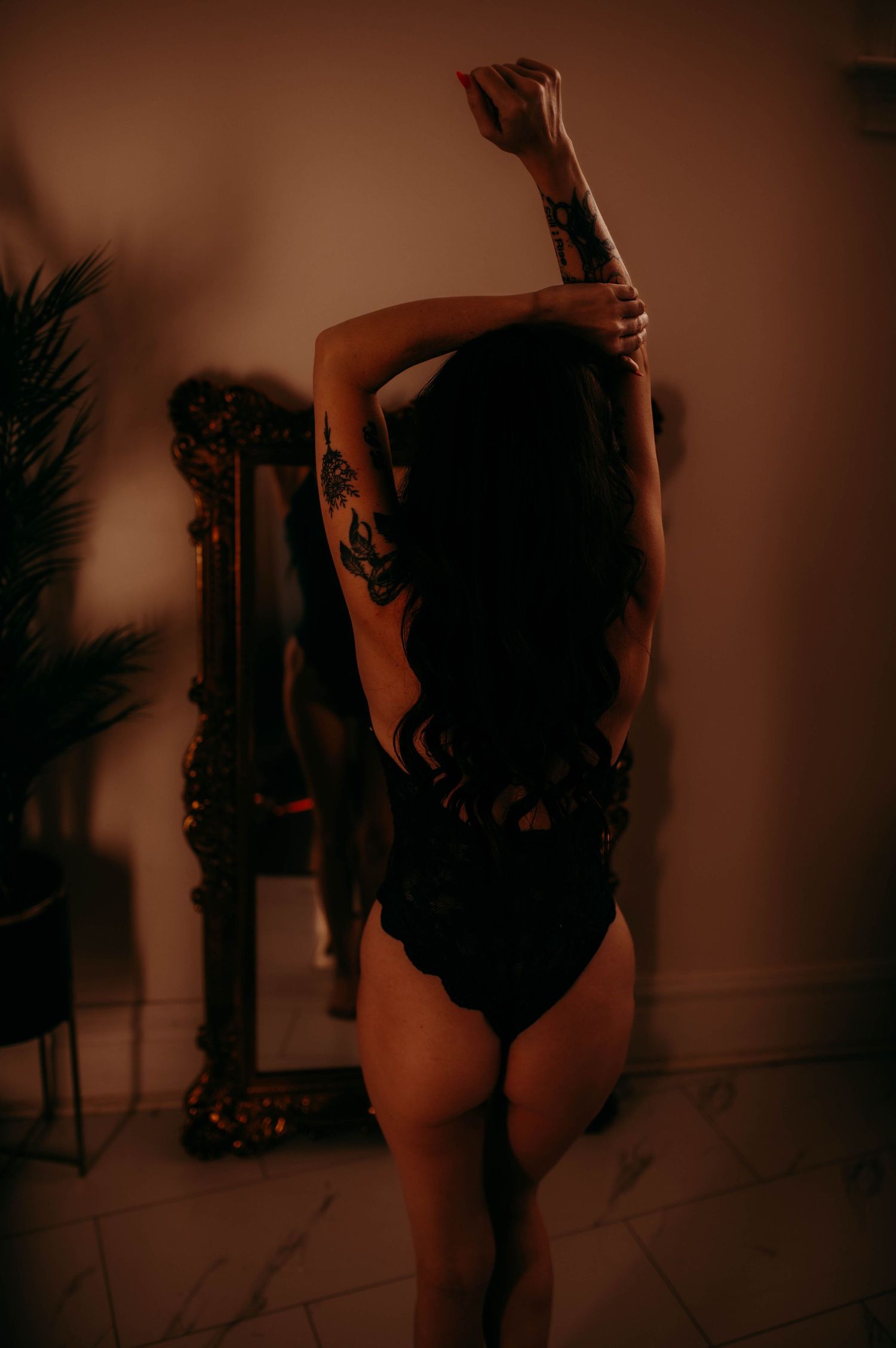 A woman in lingerie in front of a mirror.