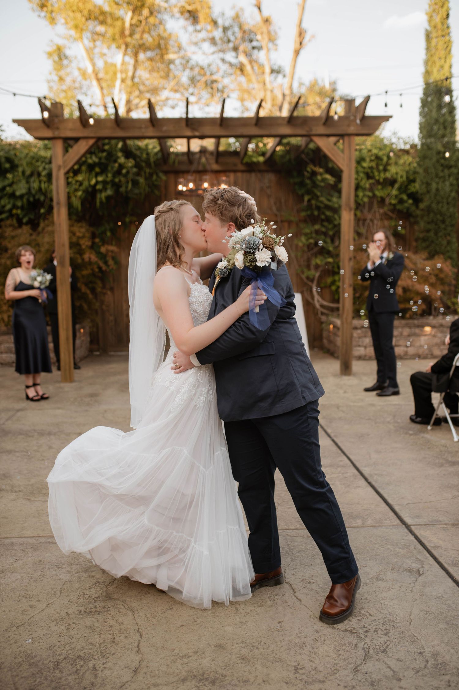 Two partners kissing at their wedding