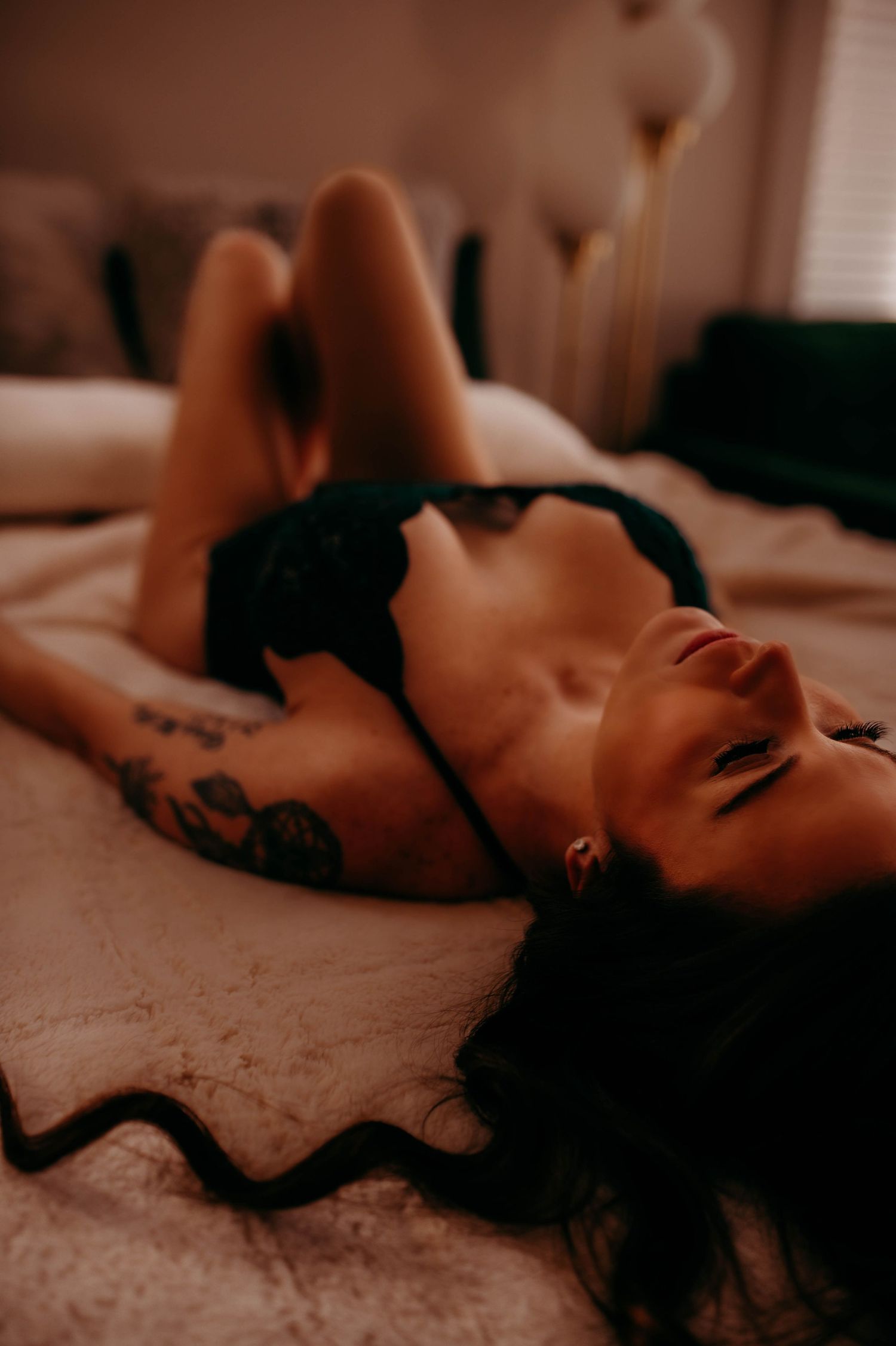 A woman in lingerie on a bed.