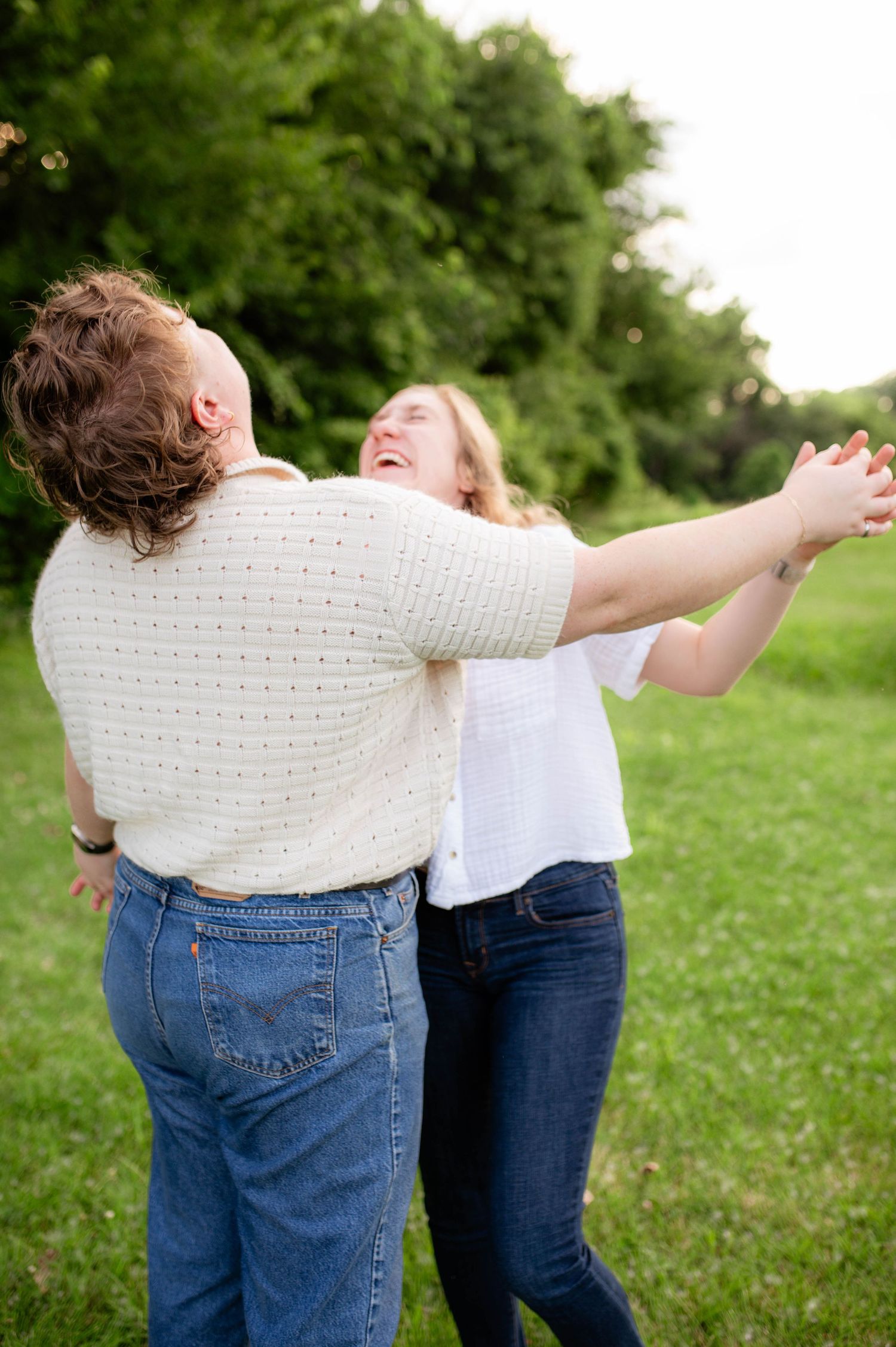 A couple laughing and holding hands.