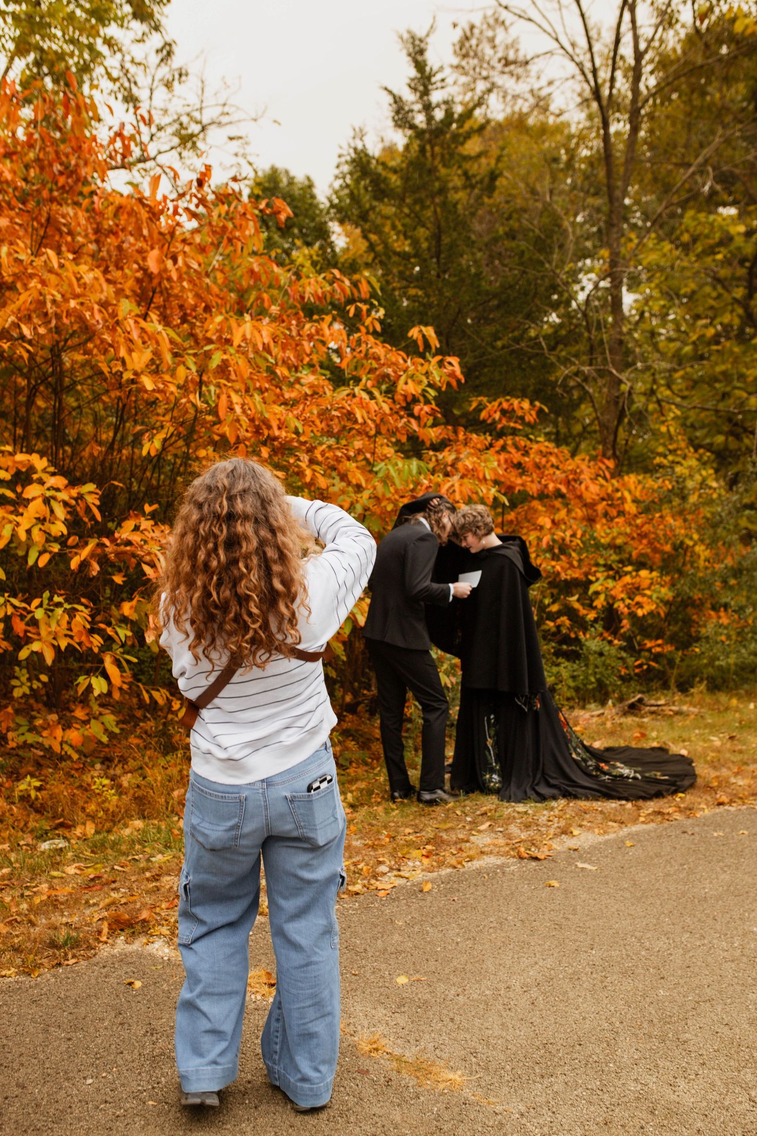 A photographer photographing a bride and groom.