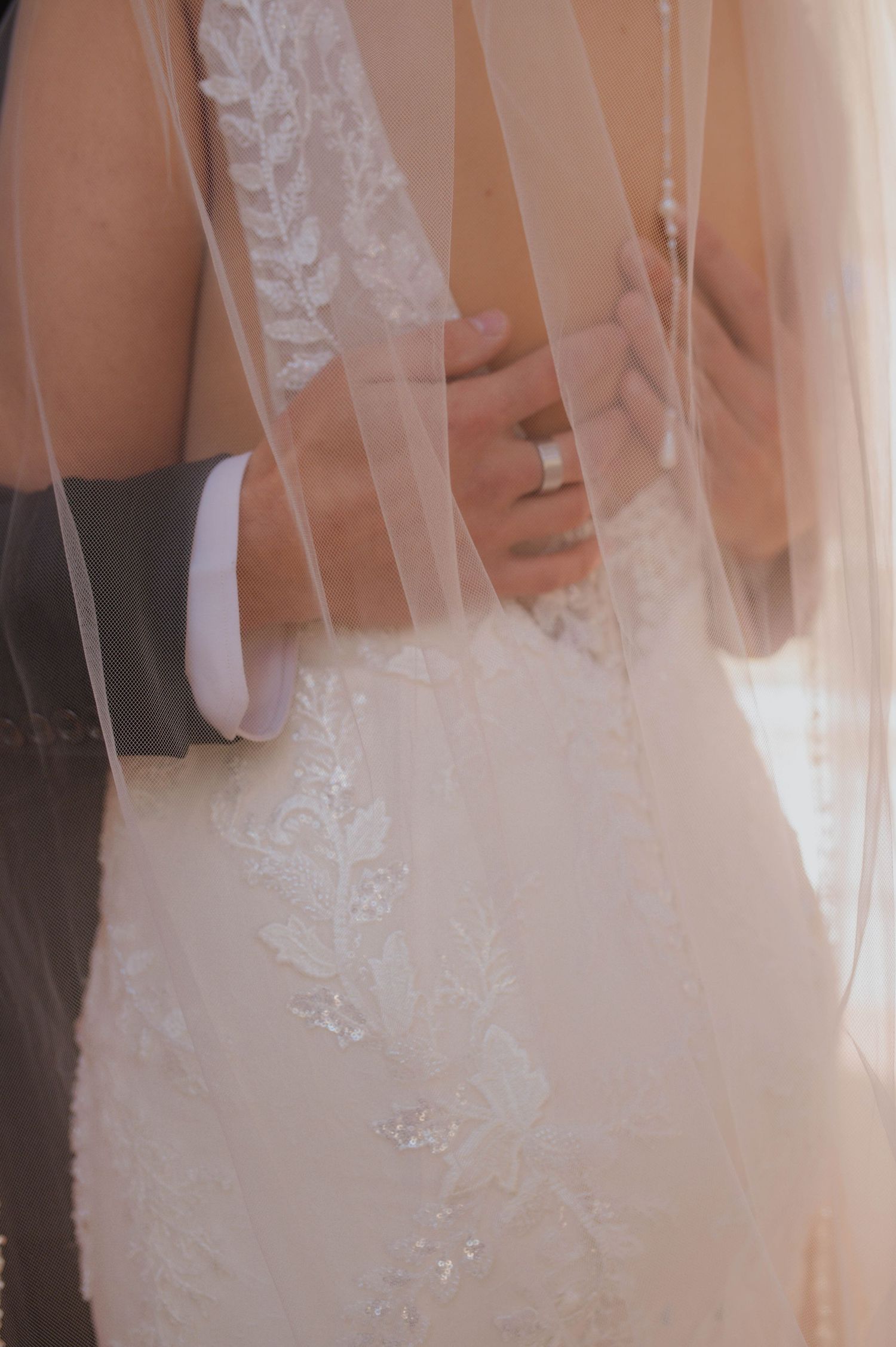 hands on back of bride's back