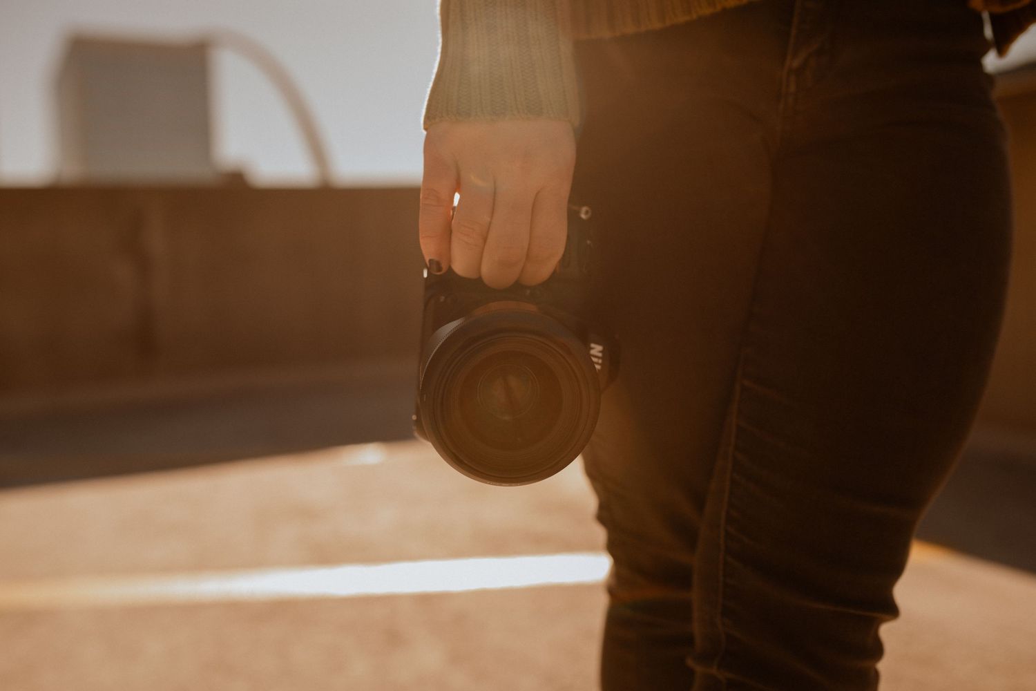 A hand holding a camera