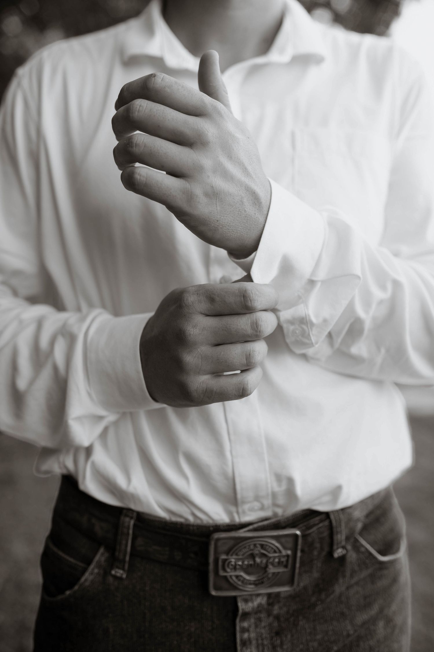 A groom adjusting his cuff links.