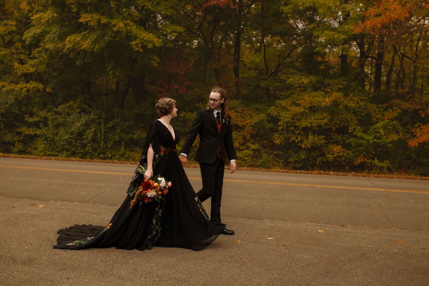 bride and groom walking down a road