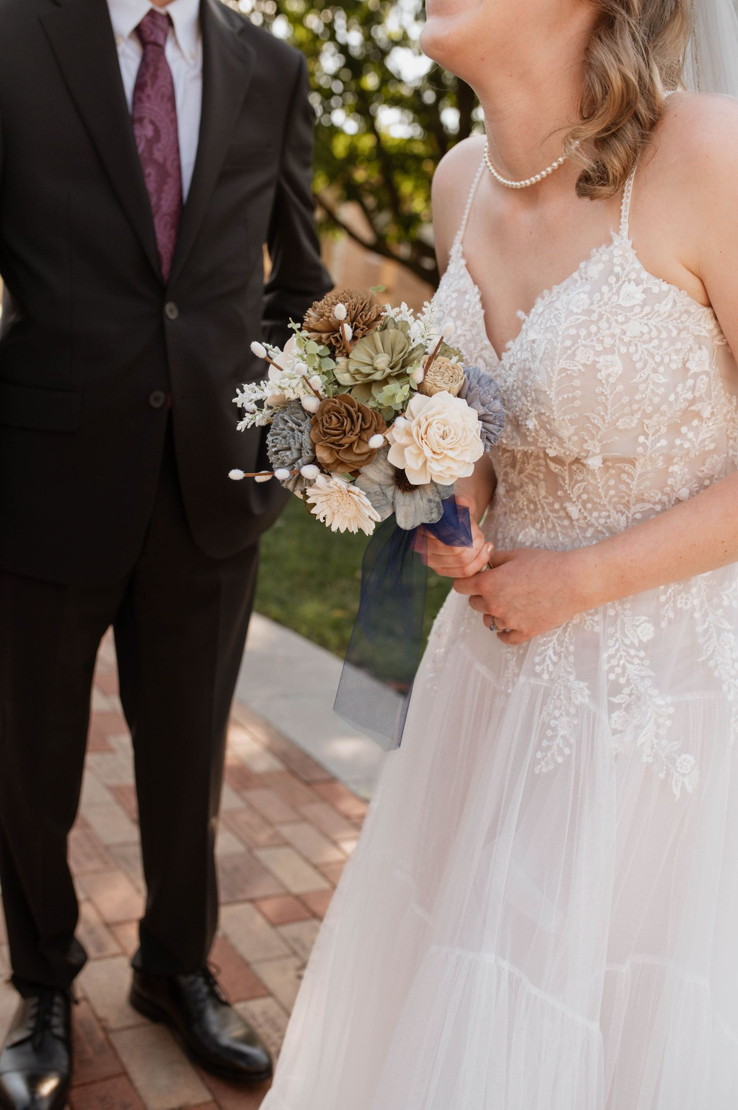 bride holding bouquet and laughing