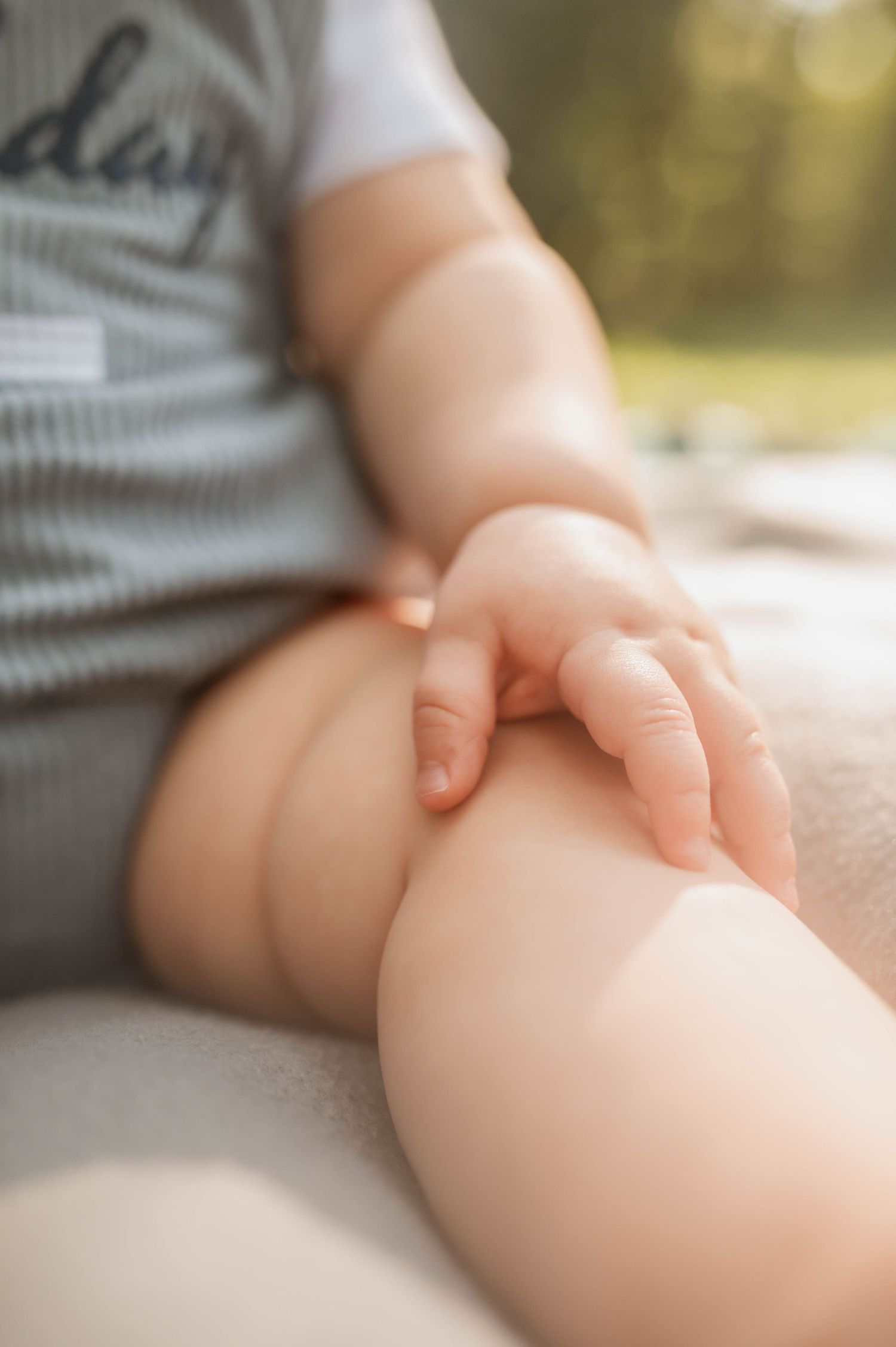 The arm and leg of a baby, showing his little folds.