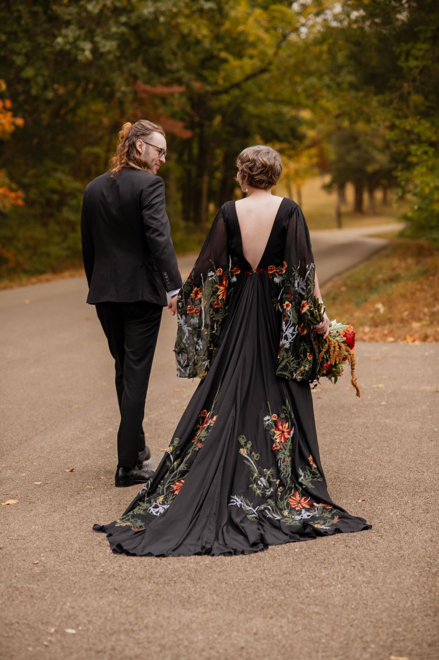 A bride and groom walking down the road.