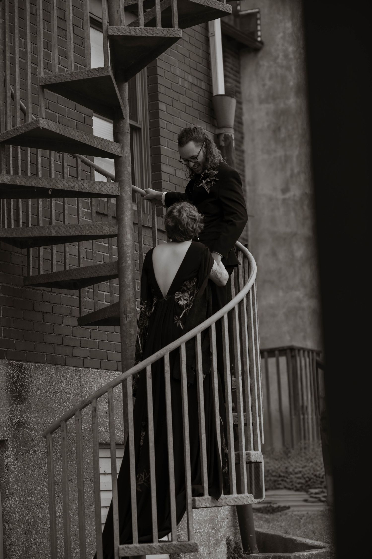 groom leading wife up stairs