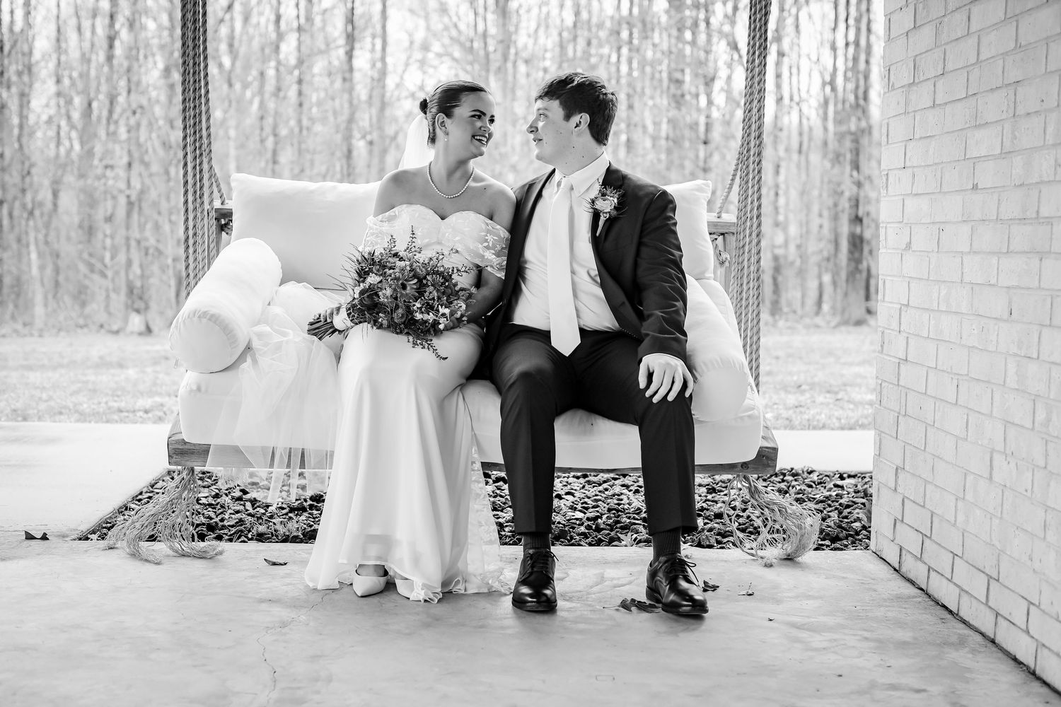 Black and white photos of wedding couple sharing intimate moments on a porch swing.