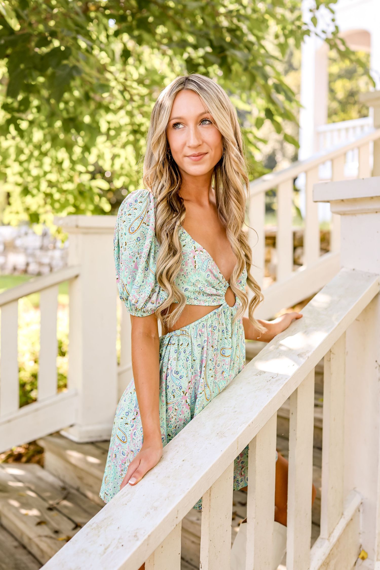 Series of portraits on white porch railing featuring floral mint green dress.