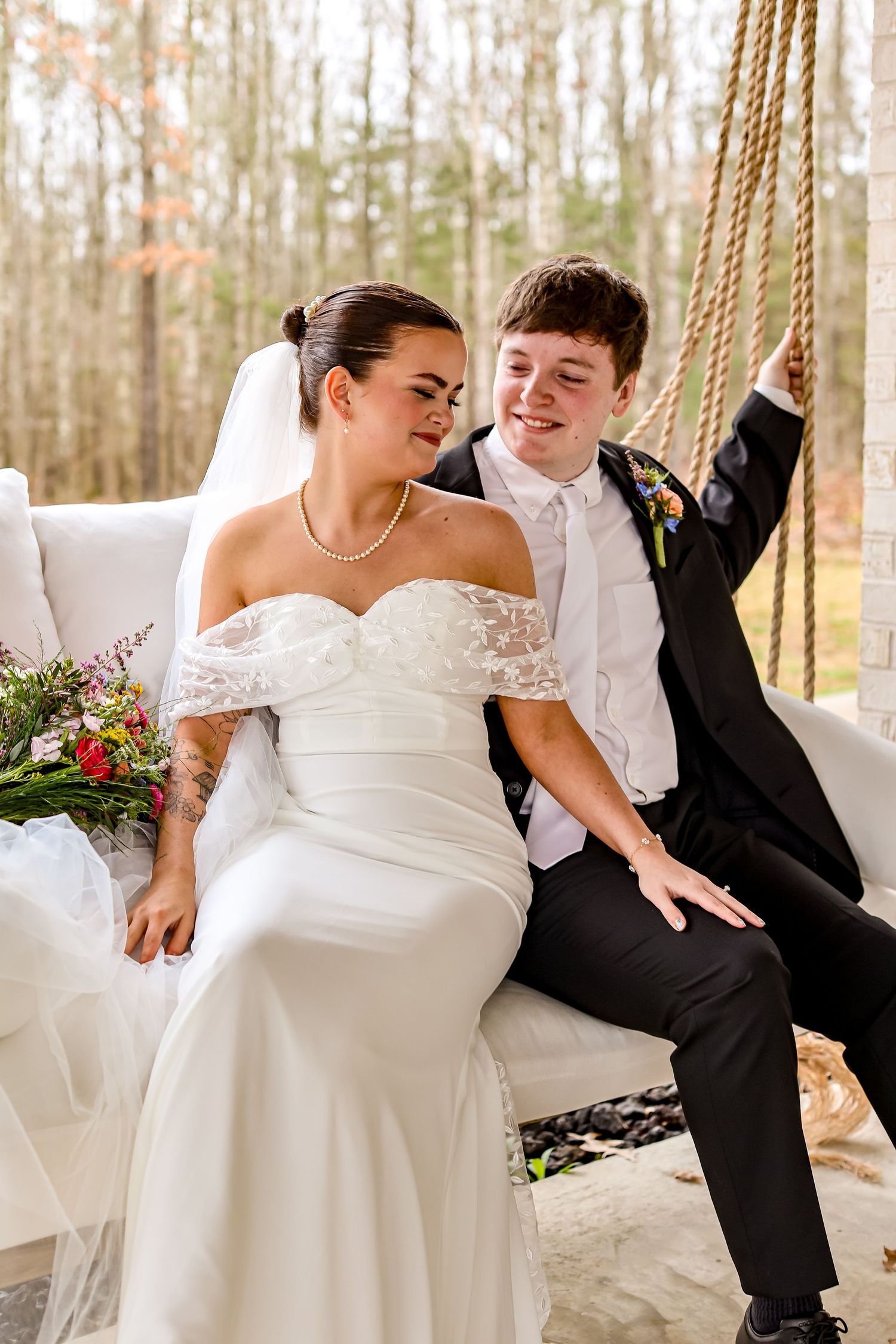 Playful wedding photos on a porch swing showing joyful moments and laughter.